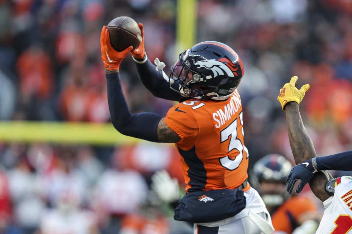 DENVER, COLORADO - OCTOBER 29: Justin Simmons #31 of the Denver Broncos intercepts a ball intended for Marquez Valdes-Scantling #11 of the Kansas City Chiefs during an NFL football game between the Denver Broncos and the Kansas City Chiefs at Empower Field At Mile High on October 29, 2023 in Denver, Colorado. (Photo by Michael Owens/Getty Images)