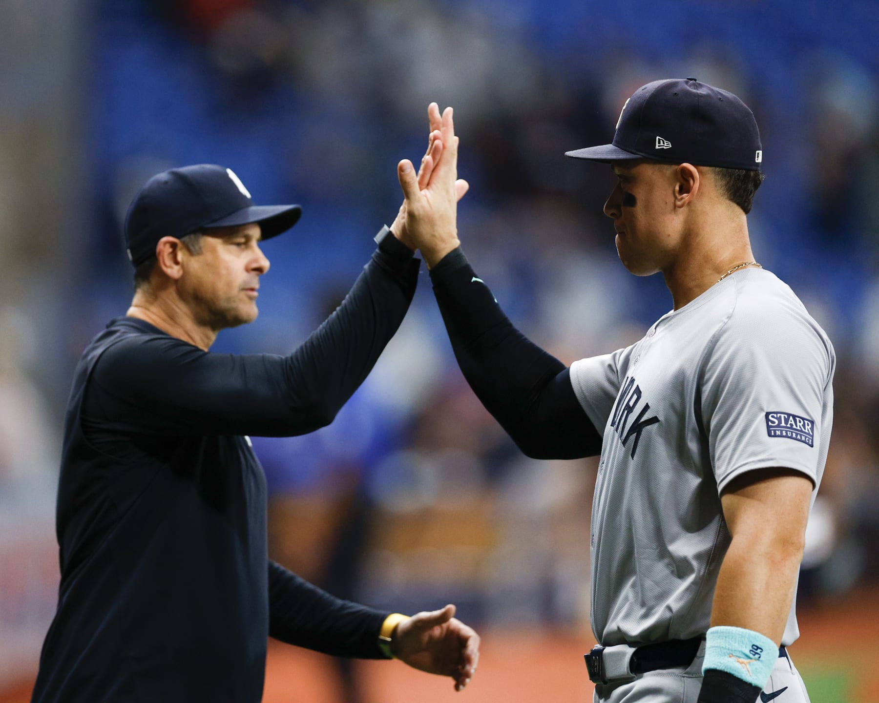 ST PETERSBURG, FLORIDA - JULY 10: Manager Aaron Boone #17 and Aaron Judge #99 of the New York Yankees celebrate a 2-1 win over the Tampa Bay Rays at Tropicana Field on July 10, 2024 in St Petersburg, Florida. (Photo by Douglas P. DeFelice/Getty Images)