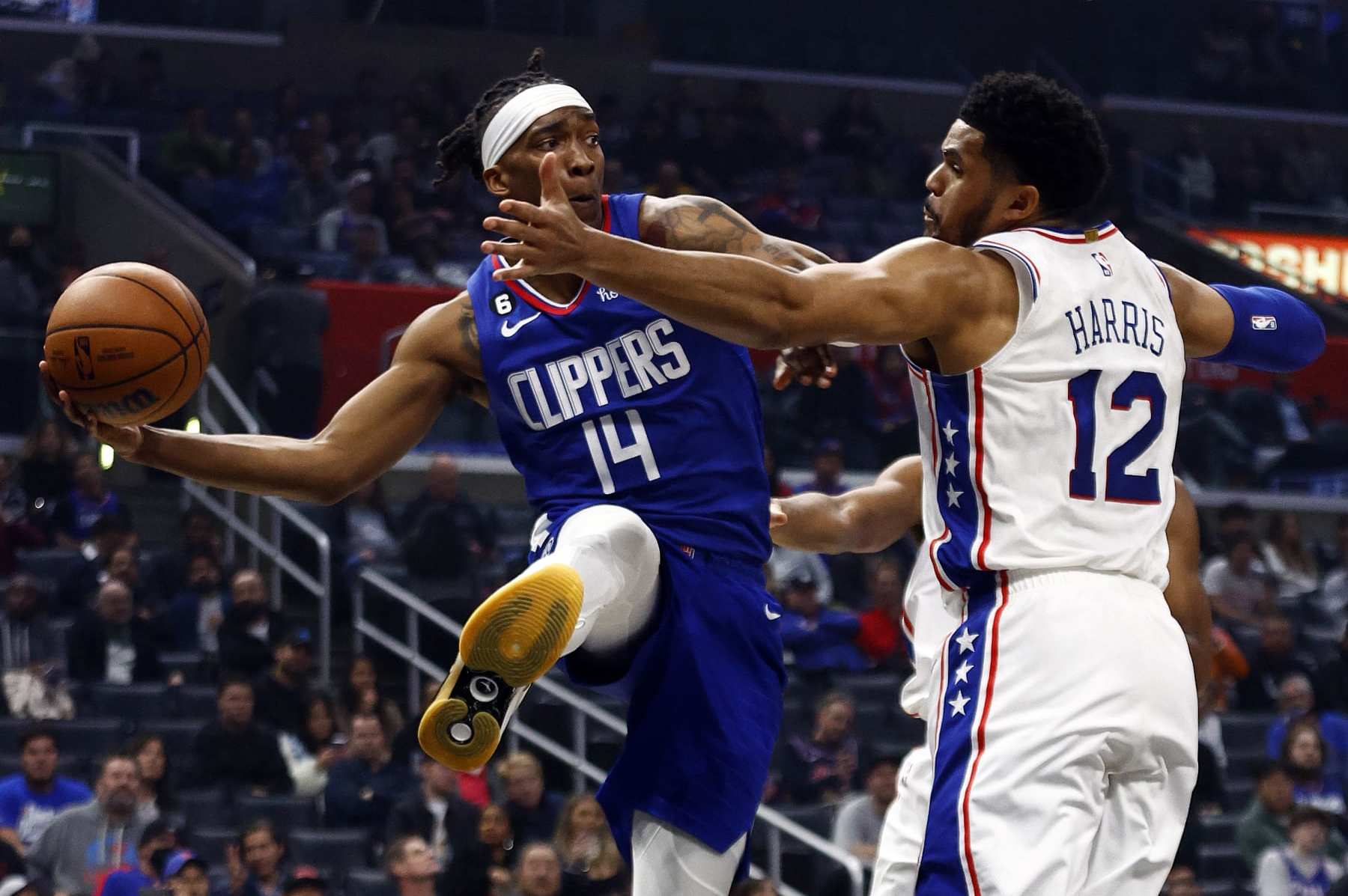 Terance Mann throws a pass around Tobias Harris Terance Mann throws a pass around Tobias Harris