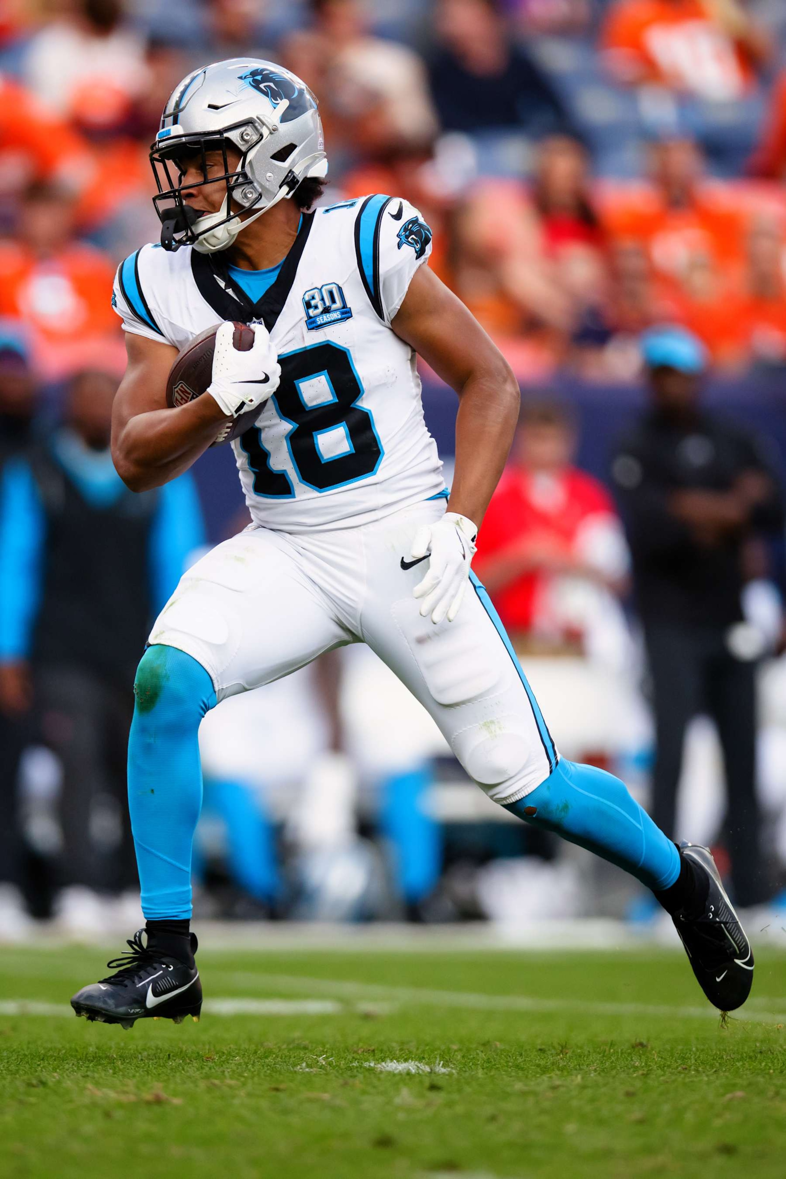 DENVER, CO - OCTOBER 27:  Wide receiver Jalen Coker #18 of the Carolina Panthers runs with the football after catching a pass during the fourth quarter against the Denver Broncos at Empower Field at Mile High on October 27, 2024 in Denver, Colorado. (Photo by Justin Edmonds/Getty Images)