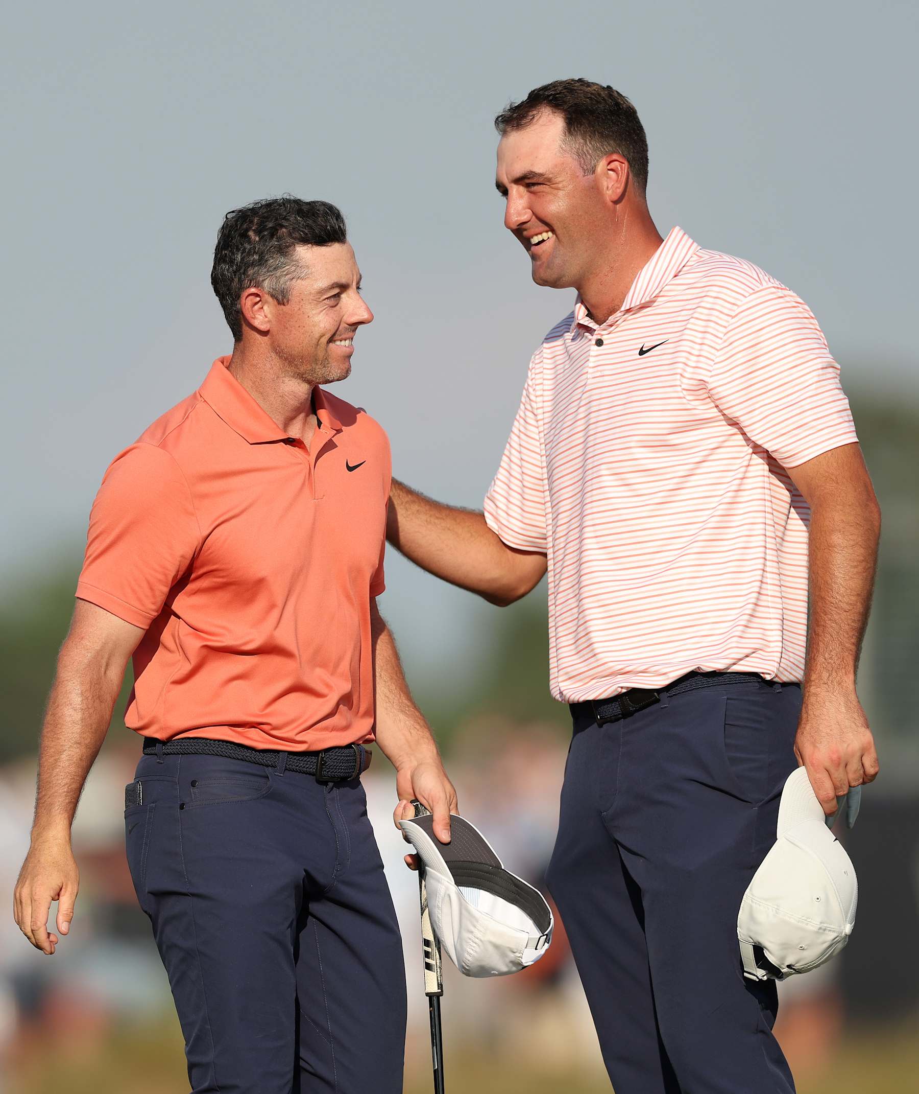 PINEHURST, NORTH CAROLINA - JUNE 13: Rory McIlroy of Northern Ireland and Scottie Scheffler of the United States speak on the 18th green around their round during the first round of the 124th U.S. Open at Pinehurst Resort on June 13, 2024 in Pinehurst, North Carolina. (Photo by Sean M. Haffey/Getty Images)