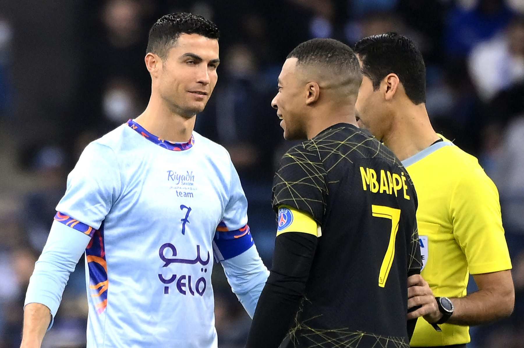 Riyadh All-Star's Portuguese forward Cristiano Ronaldo (L) chats with Paris Saint-Germain's French forward Kylian Mbappe (R) during the Riyadh Season Cup football match between the Riyadh All-Stars and Paris Saint-Germain at the King Fahd Stadium in Riyadh on January 19, 2023. (Photo by FRANCK FIFE / AFP) (Photo by FRANCK FIFE/AFP via Getty Images)