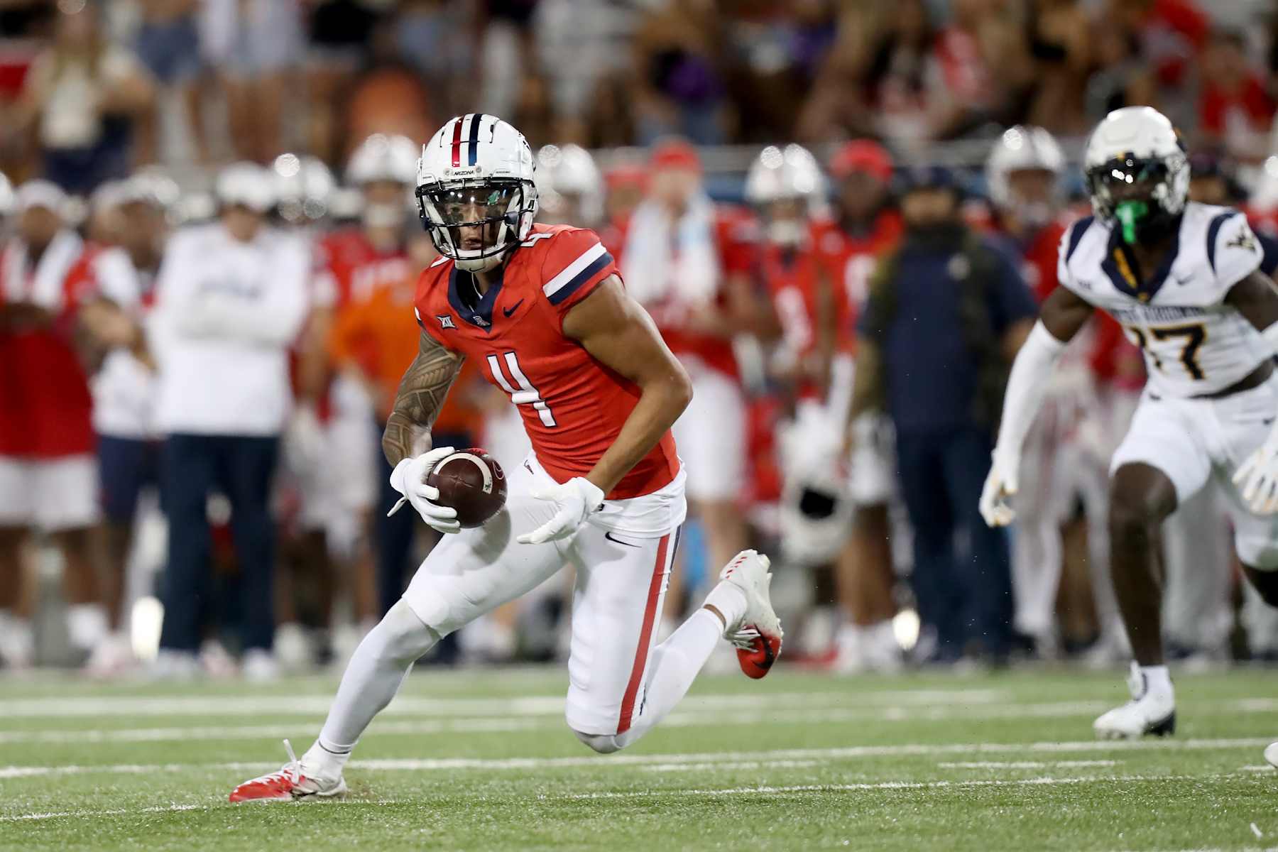 TUCSON, AZ - OCTOBER 26: Arizona Wildcats wide receiver Tetairoa McMillan #4 during the second half of a football game between the West Virginia Mountaineers and the University of Arizona Wildcats on October 26, 2024, at Arizona Stadium in Tucson, AZ. (Photo by Christopher Hook/Icon Sportswire via Getty Images)