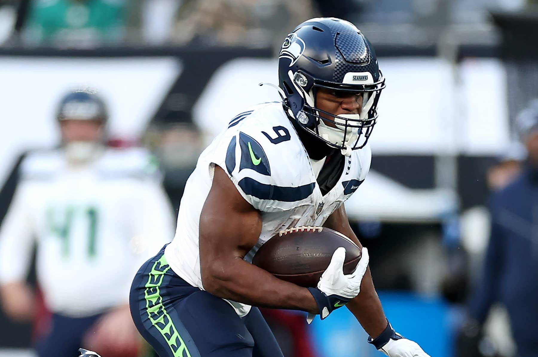 EAST RUTHERFORD, NEW JERSEY - DECEMBER 01: Kenneth Walker III #9 of the Seattle Seahawks breaks a tackle by D.J. Reed #4 of the New York Jets in the fourth quarter of a game at MetLife Stadium on December 01, 2024 in East Rutherford, New Jersey. (Photo by Luke Hales/Getty Images)