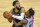 Minnesota Timberwolves center Karl-Anthony Towns, left, is fouled by Miami Heat forward Jimmy Butler during the second half of an NBA basketball game Friday, April 16, 2021, in Minneapolis. The Timberwolves won 119-111. (AP Photo/Craig Lassig)