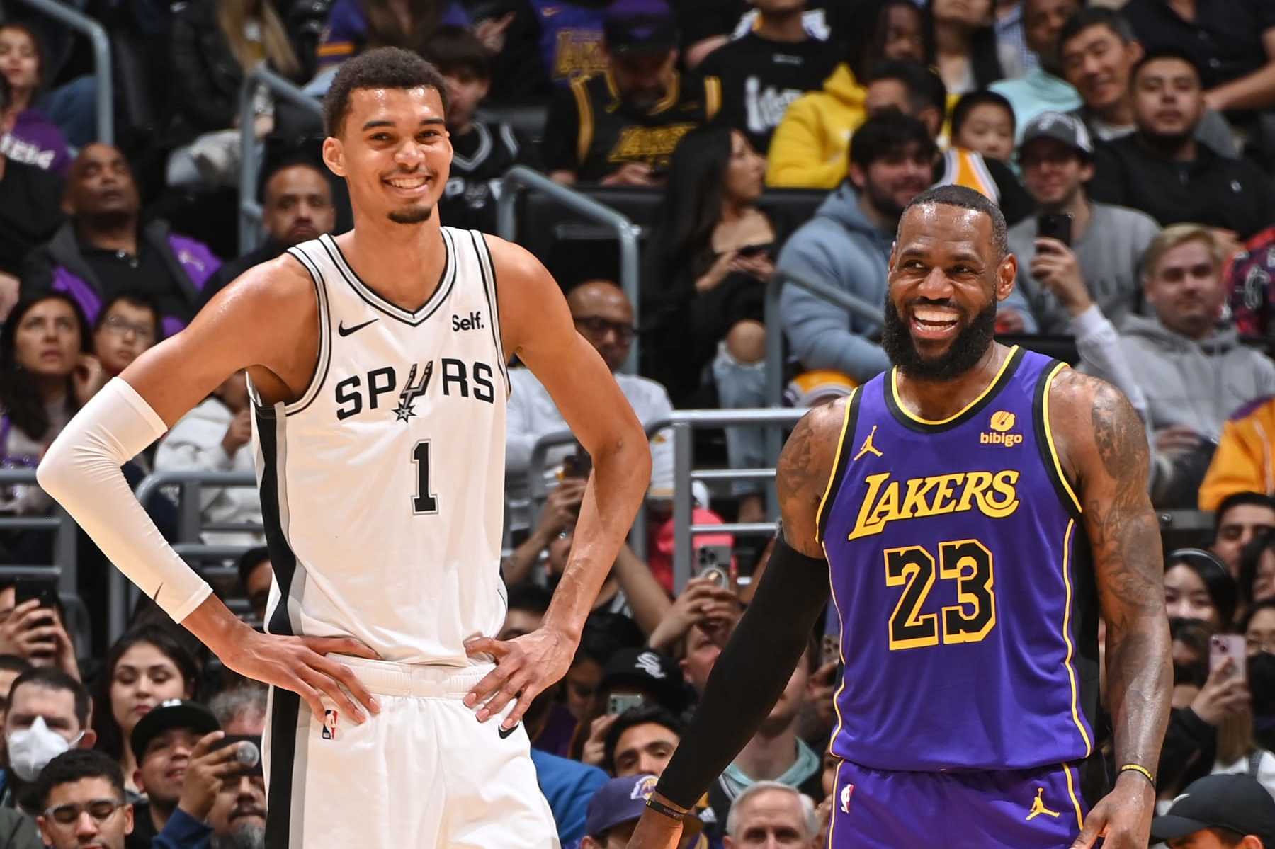 LOS ANGELES, CA - FEBRUARY 23: Victor Wembanyama #1 of the San Antonio Spurs and LeBron James #23 of the Los Angeles Lakers smile during the game on Feburary 23, 2024 at Crypto.Com Arena in Los Angeles, California. NOTE TO USER: User expressly acknowledges and agrees that, by downloading and/or using this Photograph, user is consenting to the terms and conditions of the Getty Images License Agreement. Mandatory Copyright Notice: Copyright 2024 NBAE (Photo by Andrew D. Bernstein/NBAE via Getty Images)
