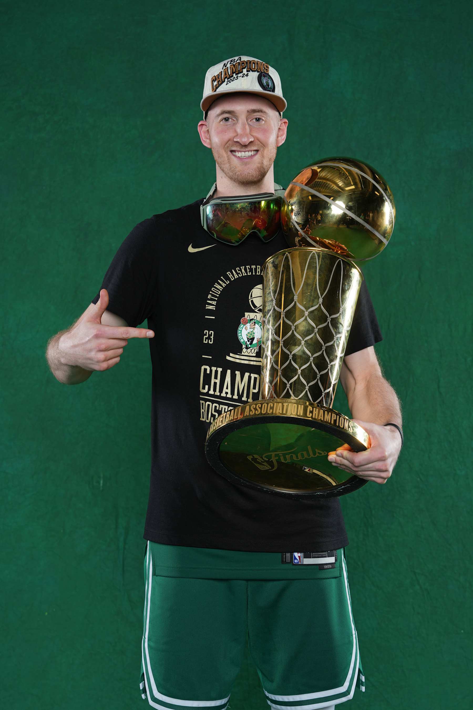 BOSTON, MA - JUNE 17: Sam Hauser #30 of the Boston Celtics poses for a portrait with the Larry O'Brian Trophy after winning Game 5 of the 2024 NBA Finals on June 17, 2024 at the TD Garden in Boston, Massachusetts. NOTE TO USER: User expressly acknowledges and agrees that, by downloading and or using this photograph, User is consenting to the terms and conditions of the Getty Images License Agreement. Mandatory Copyright Notice: Copyright 2024 NBAE  (Photo by Jesse D. Garrabrant/NBAE via Getty Images)