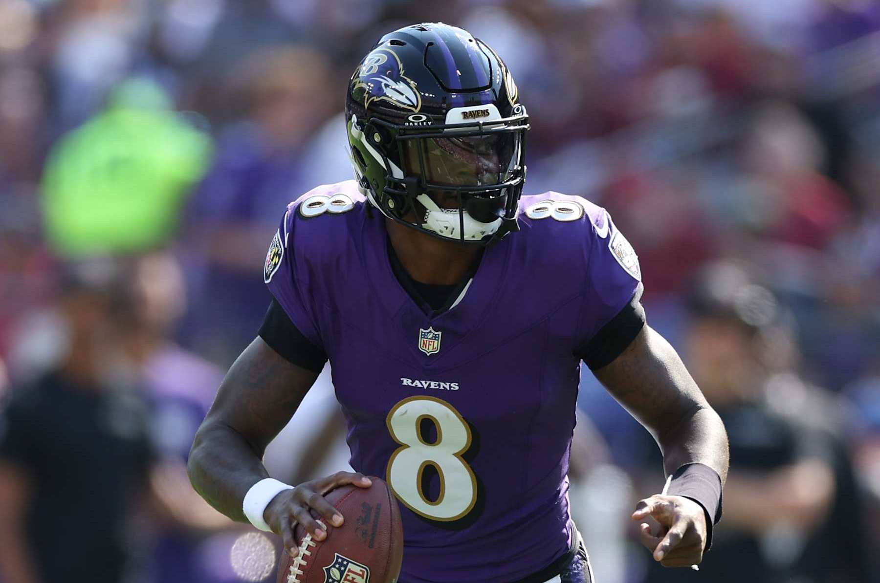 BALTIMORE, MARYLAND - OCTOBER 13: Quarterback Lamar Jackson #8 of the Baltimore Ravens rushes with the ball against the Washington Commanders at M&T Bank Stadium on October 13, 2024 in Baltimore, Maryland. (Photo by Patrick Smith/Getty Images)