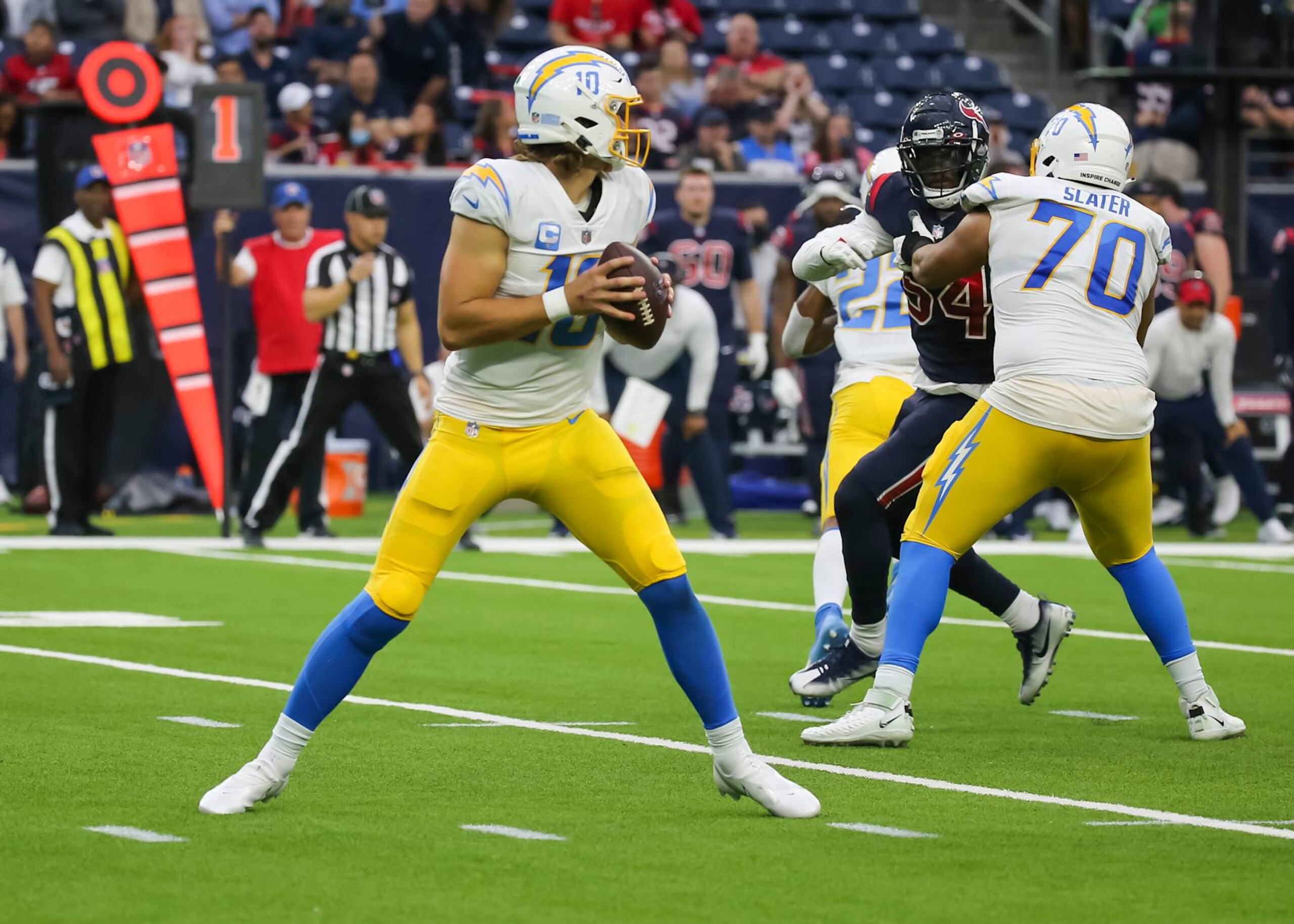 HOUSTON, TX - DECEMBER 26:  Los Angeles Chargers quarterback Justin Herbert (10) looks for an open receiver in the fourth quarter during the NFL game between the Los Angeles Chargers and Houston Texans on December 26, 2021 at NRG Stadium in Houston, Texas.  (Photo by Leslie Plaza Johnson/Icon Sportswire via Getty Images)