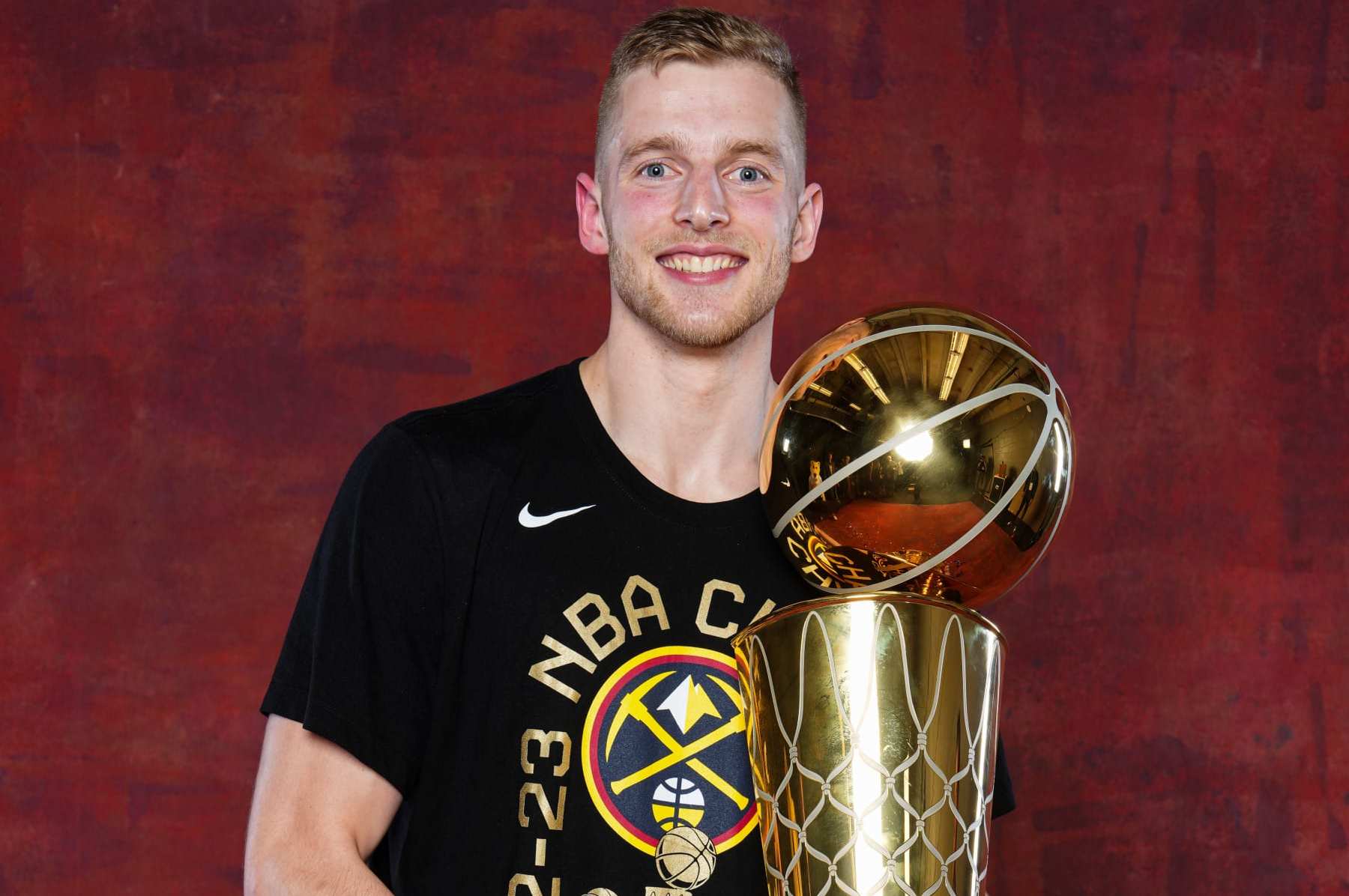 DENVER, CO - JUNE 12: Jack White #10 of the Denver Nuggets poses for a portrait with the Larry O'Brien Trophy after winning Game Five of the 2023 NBA Finals on June 12, 2023 at Ball Arena in Denver, Colorado. NOTE TO USER: User expressly acknowledges and agrees that, by downloading and or using this Photograph, user is consenting to the terms and conditions of the Getty Images License Agreement. Mandatory Copyright Notice: Copyright 2023 NBAE (Photo by Jesse D. Garrabrant/NBAE via Getty Images)