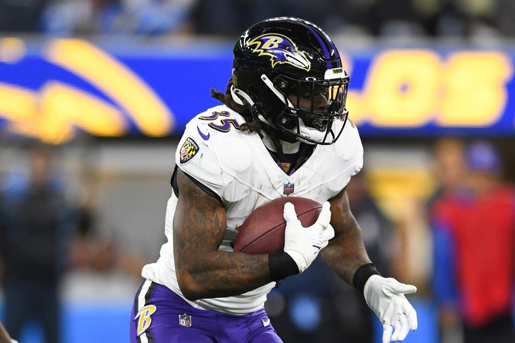 INGLEWOOD, CA - NOVEMBER 26: Baltimore Ravens running back Gus Edwards (35) runs the ball during the NFL regular season game between the Baltimore Ravens and the Los Angeles Chargers on November 26, 2023, at SoFi Stadium in Inglewood, CA. (Photo by Brian Rothmuller/Icon Sportswire via Getty Images)