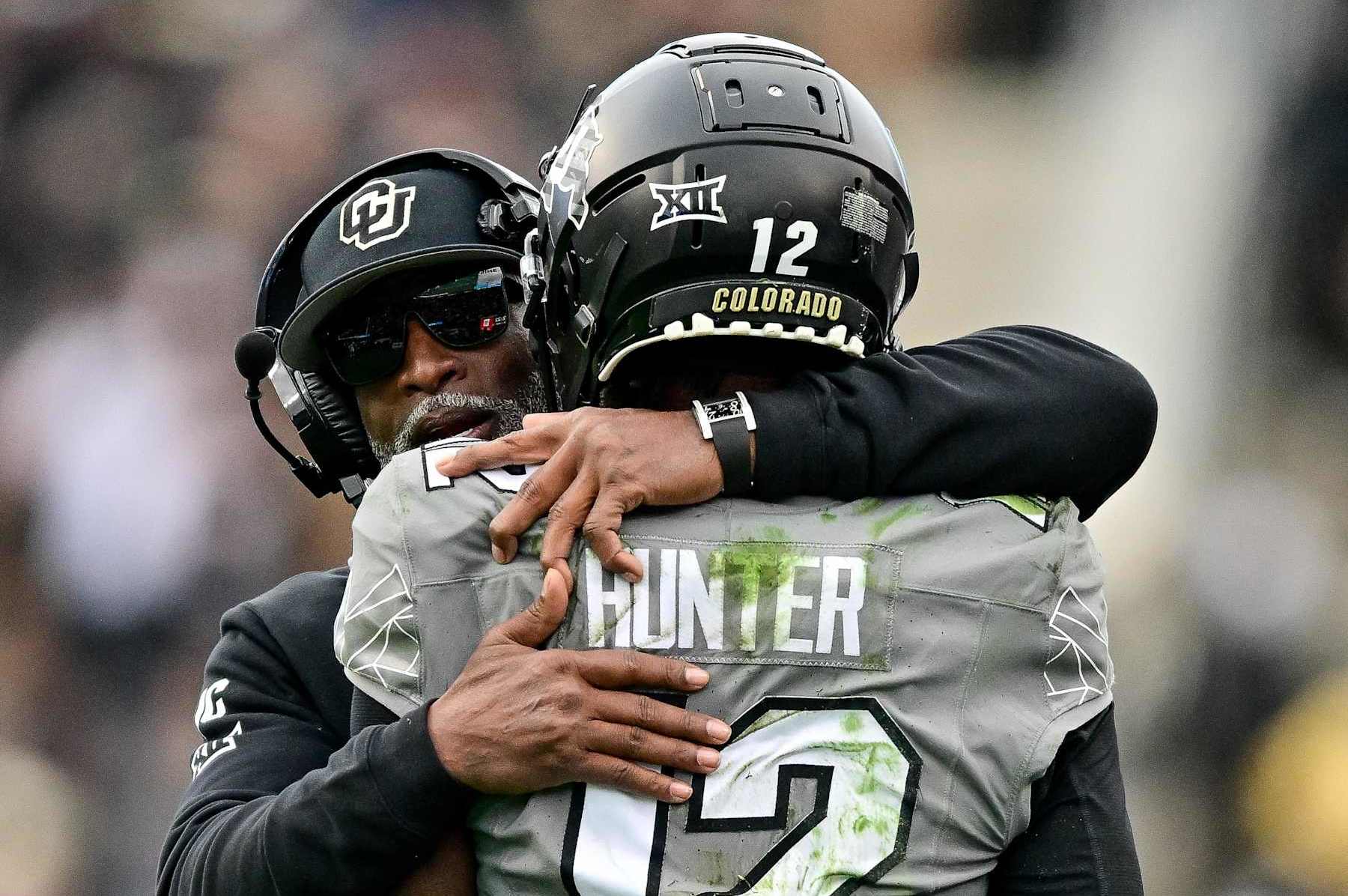 BOULDER, CO - NOVEMBER 16:  Travis Hunter #12 of the Colorado Buffaloes celebrates with head coach Deion Sanders after scoring a fourth quarter touchdown against the Utah Utes at Folsom Field on November 16, 2024 in Boulder, Colorado. (Photo by Dustin Bradford/Getty Images)