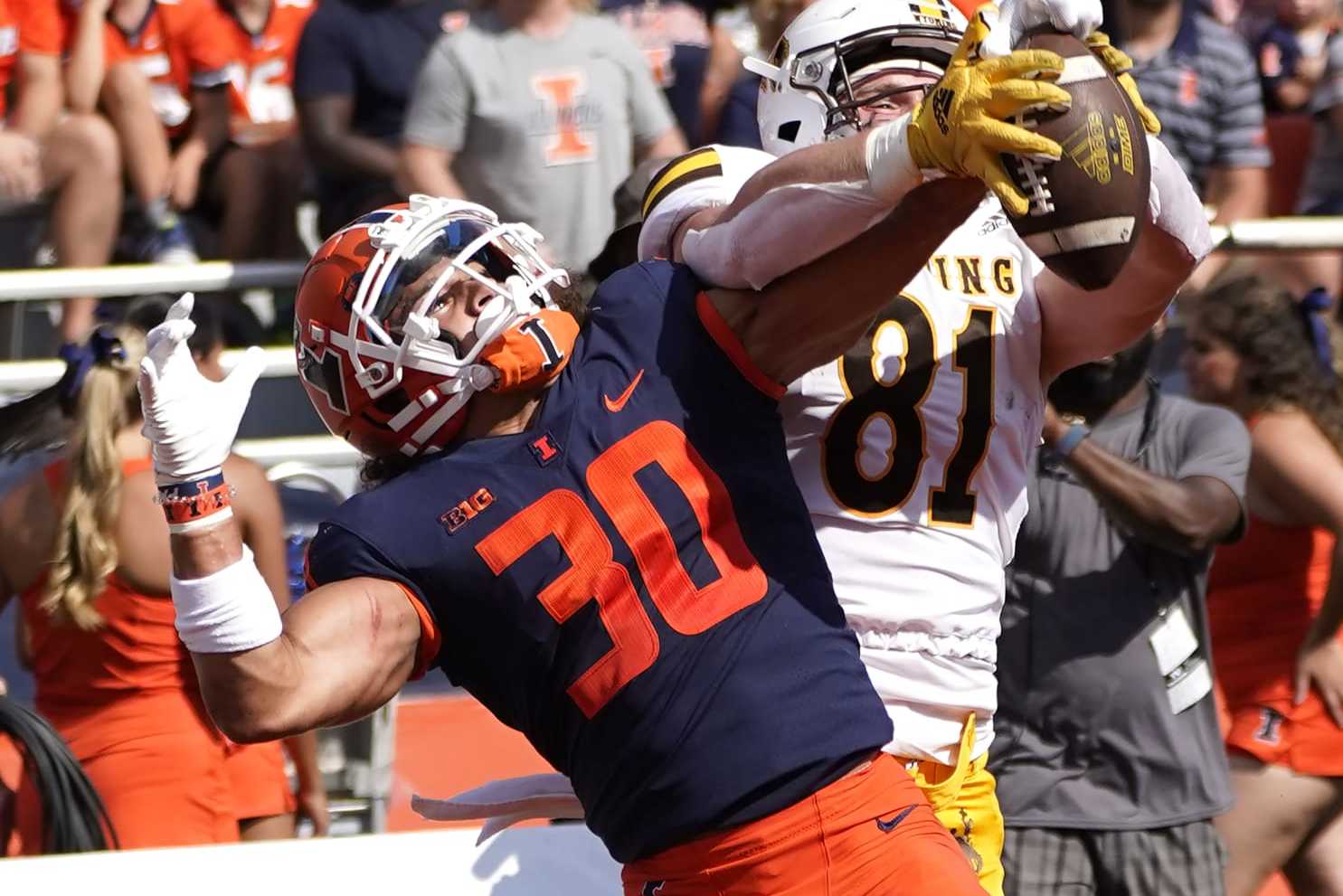 Illinois defensive back Sydney Brown (30) breaks up a pass intended for Wyoming tight end Treyton Welch in the end zone during an NCAA college football game, Sunday, Aug. 28, 2022, in Champaign, Ill. (AP Photo/Charles Rex Arbogast)