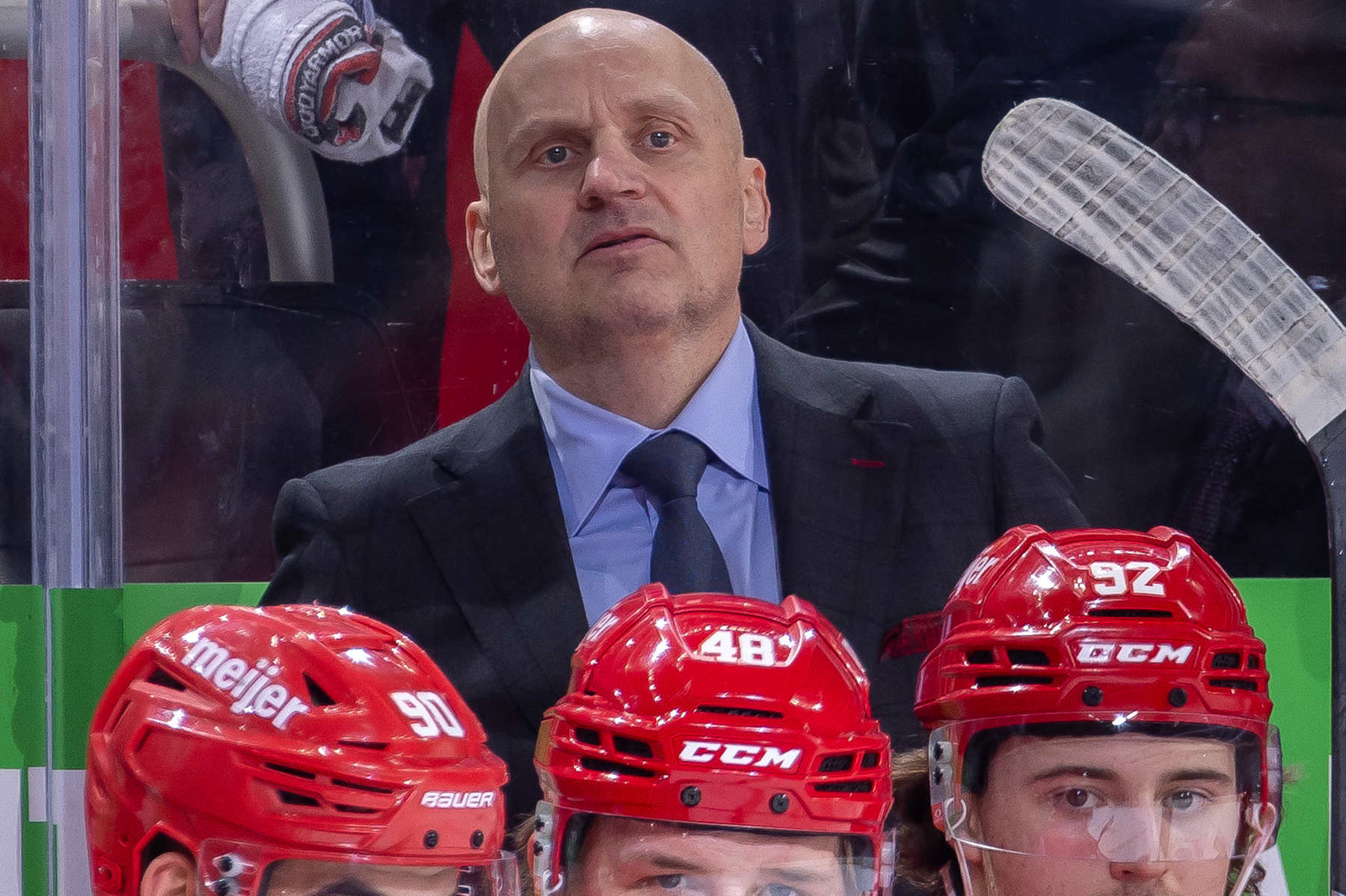 DETROIT, MICHIGAN - DECEMBER 01: Head coach Derek Lalonde of the Detroit Red Wings watches the action from the bench against the Vancouver Canucks during the first period at Little Caesars Arena on December 1, 2024 in Detroit, Michigan. (Photo by Dave Reginek/NHLI via Getty Images)