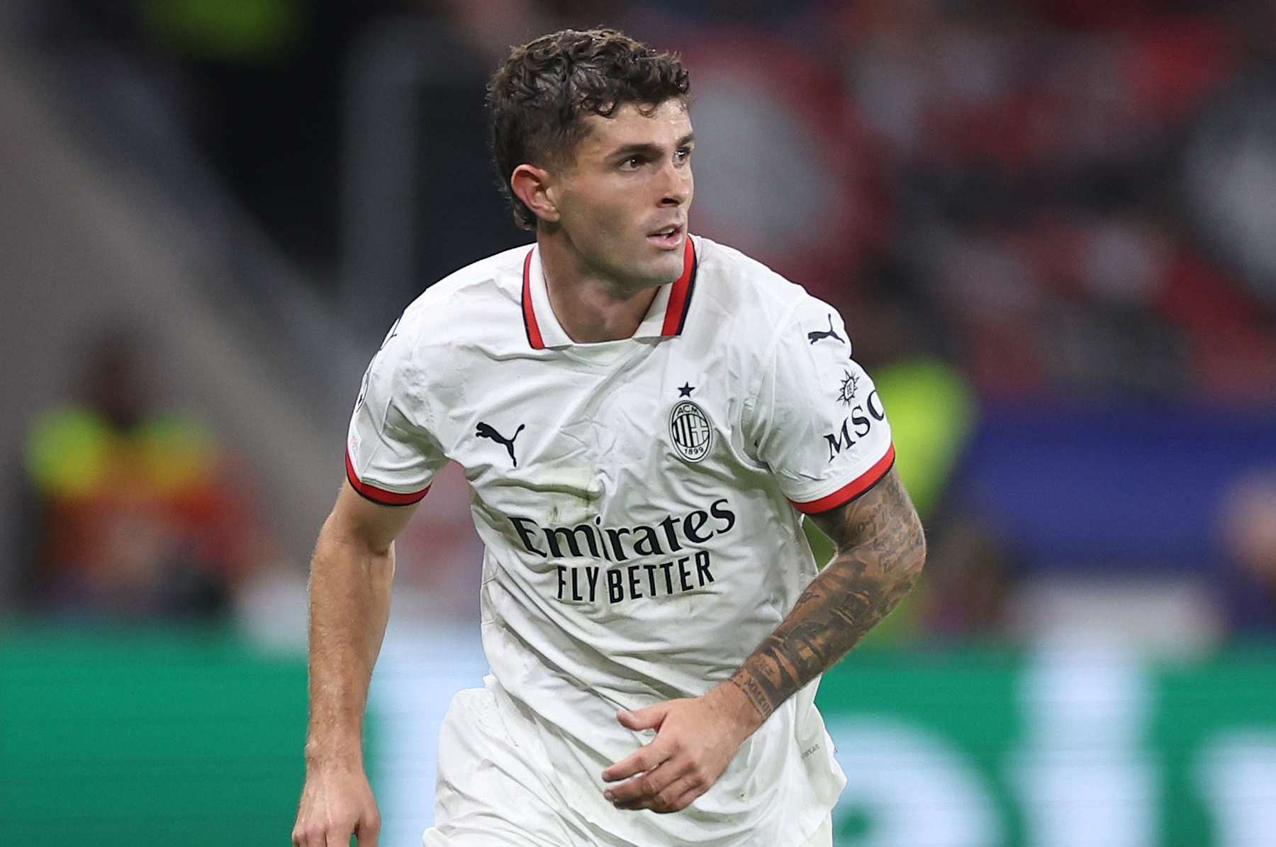LEVERKUSEN, GERMANY - OCTOBER 01: Christian Pulisic of Milan runs with the ball during the UEFA Champions League 2024/25 League Phase MD2 match between Bayer 04 Leverkusen and AC Milan at BayArena on October 01, 2024 in Leverkusen, Germany. (Photo by Lars Baron/Getty Images)