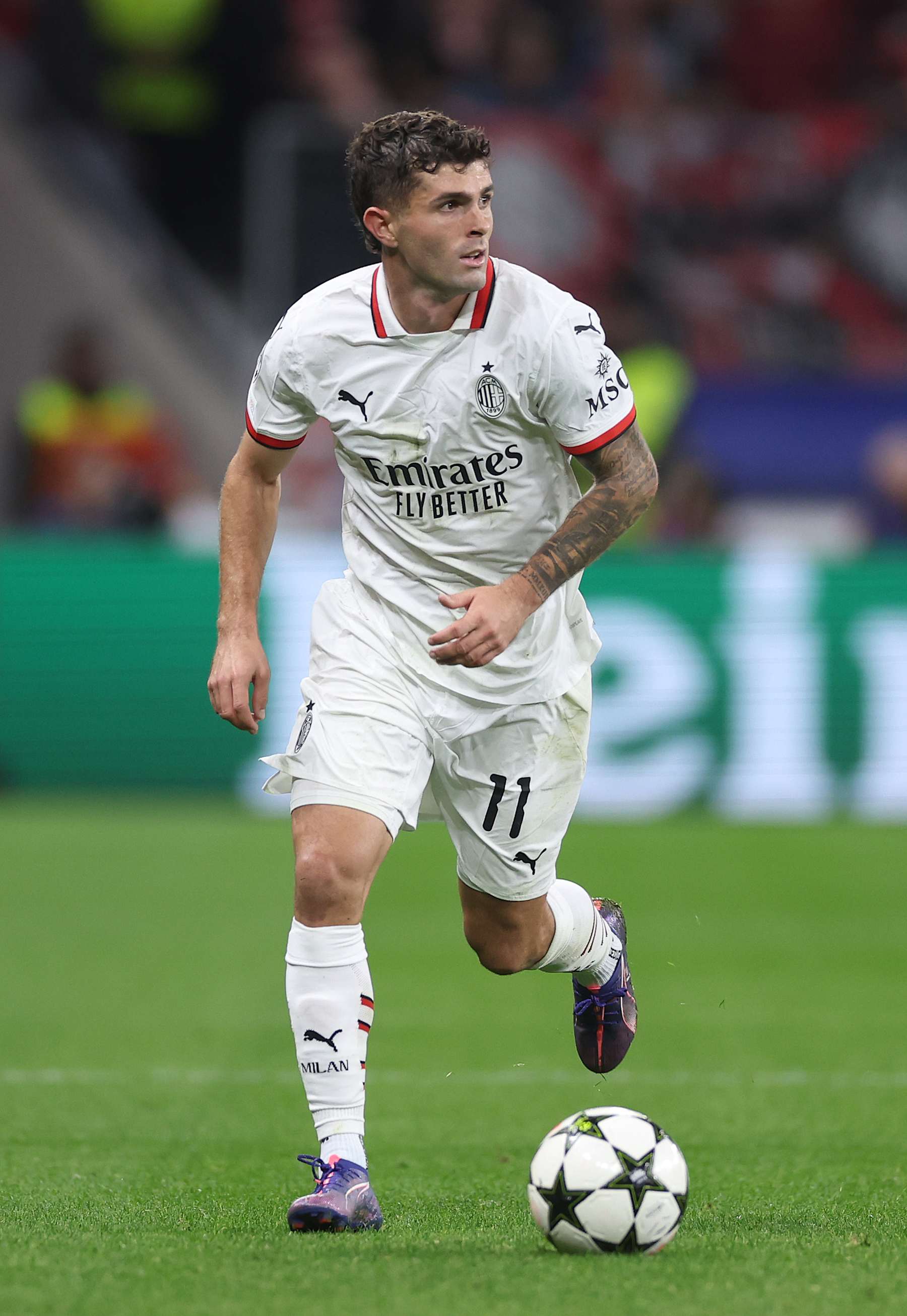 LEVERKUSEN, GERMANY - OCTOBER 01: Christian Pulisic of Milan runs with the ball during the UEFA Champions League 2024/25 League Phase MD2 match between Bayer 04 Leverkusen and AC Milan at BayArena on October 01, 2024 in Leverkusen, Germany. (Photo by Lars Baron/Getty Images)