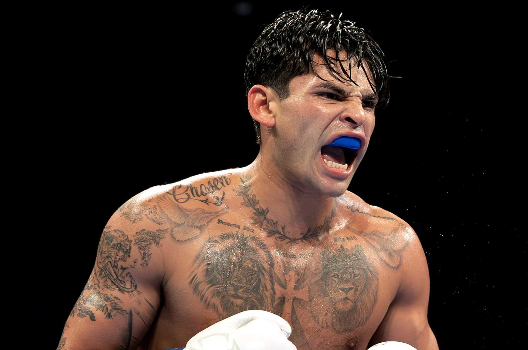 NEW YORK, NEW YORK - APRIL 20:   Ryan Garcia (white trunks) reacts against Devin Haney (gray trunks) during their WBC Super Lightweight title bout at Barclays Center on April 20, 2024 in New York City.  (Photo by Al Bello/Getty Images)
