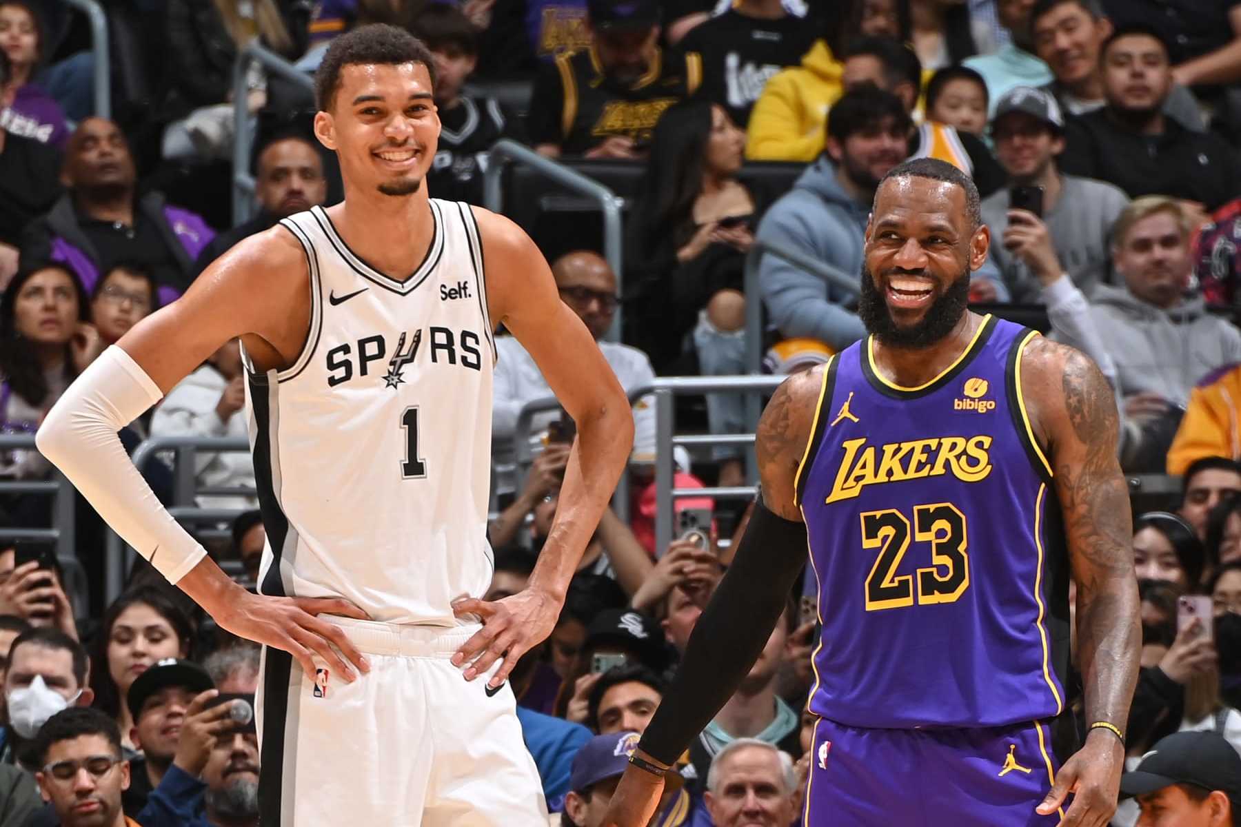 LOS ANGELES, CA - FEBRUARY 23: Victor Wembanyama #1 of the San Antonio Spurs and LeBron James #23 of the Los Angeles Lakers smile during the game on Feburary 23, 2024 at Crypto.Com Arena in Los Angeles, California. NOTE TO USER: User expressly acknowledges and agrees that, by downloading and/or using this Photograph, user is consenting to the terms and conditions of the Getty Images License Agreement. Mandatory Copyright Notice: Copyright 2024 NBAE (Photo by Andrew D. Bernstein/NBAE via Getty Images)