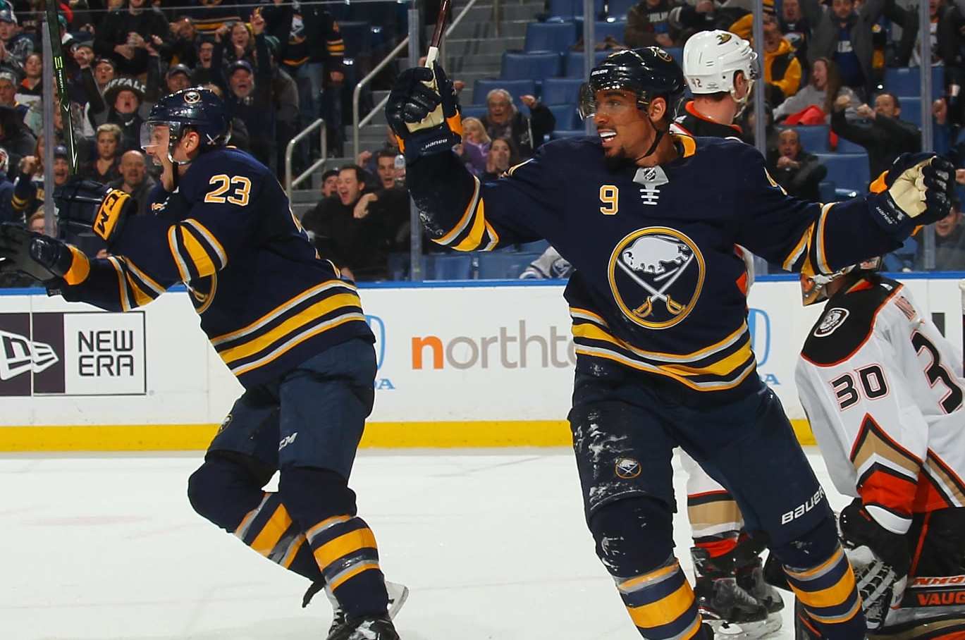 BUFFALO, NY - FEBRUARY 6: Evander Kane #9 and Sam Reinhart #23 of the Buffalo Sabres react as Ryan O'Reilly (not shown) scores a late third period goal against Ryan Miller #30 of the Anaheim Ducks to tie an NHL game on February 6, 2018 at KeyBank Center in Buffalo, New York. Anaheim won in overtime, 4-3. (Photo by Bill Wippert/NHLI via Getty Images)