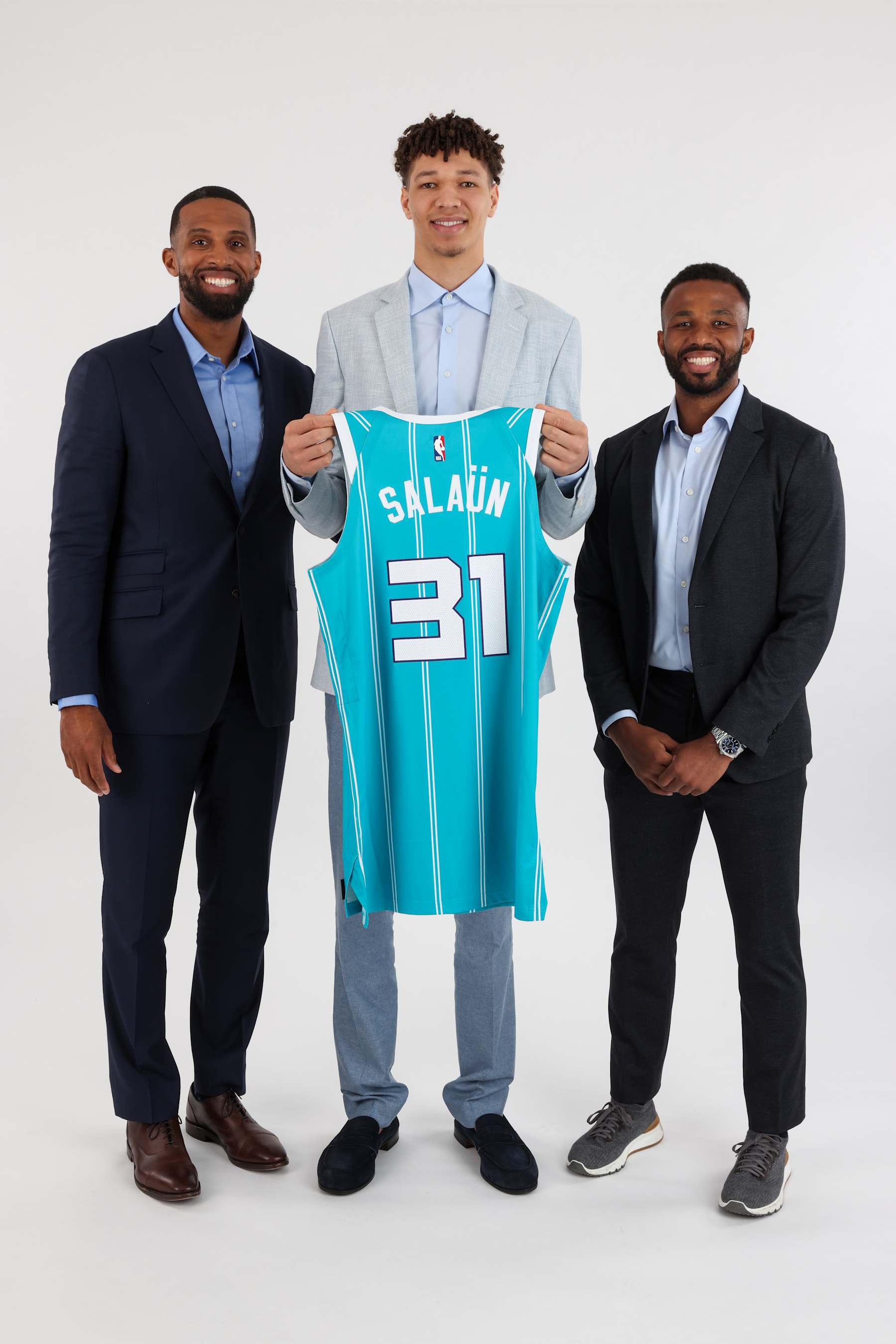 CHARLOTTE, NC - JUNE 28: Head Coach Charles Lee, Tidjane Salaün and Jeff Peterson of the Charlotte Hornets pose for a portrait on June 28, 2024 at Spectrum Center in Charlotte, North Carolina. NOTE TO USER: User expressly acknowledges and agrees that, by downloading and or using this photograph, User is consenting to the terms and conditions of the Getty Images License Agreement.  Mandatory Copyright Notice:  Copyright 2024 NBAE (Photo by Kent Smith/NBAE via Getty Images)