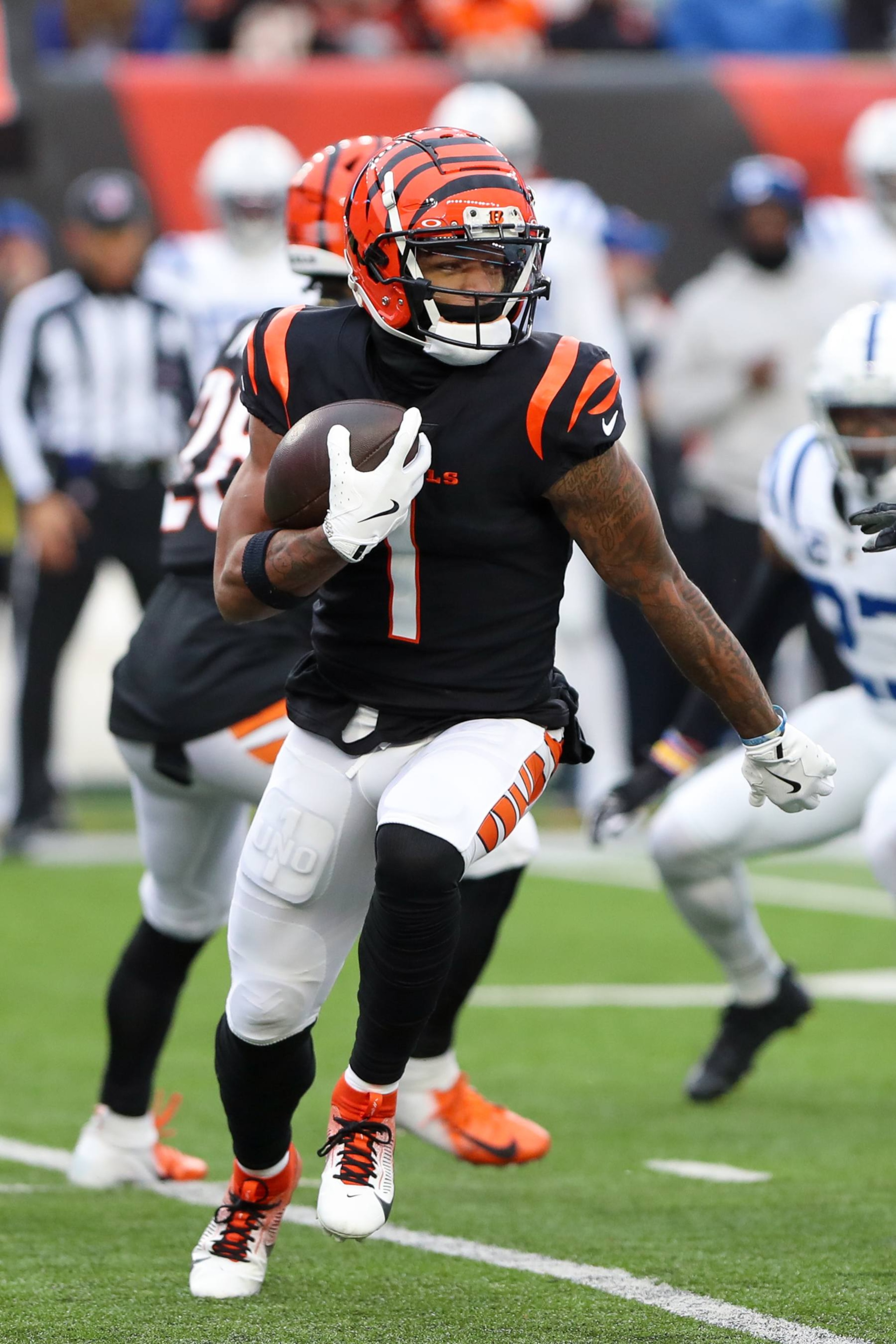 CINCINNATI, OH - DECEMBER 10: Cincinnati Bengals wide receiver Ja'Marr Chase (1) carries the ball during the game against the Indianapolis Colts and the Cincinnati Bengals on December 10, 2023, at Paycor Stadium in Cincinnati, OH. (Photo by Ian Johnson/Icon Sportswire via Getty Images)