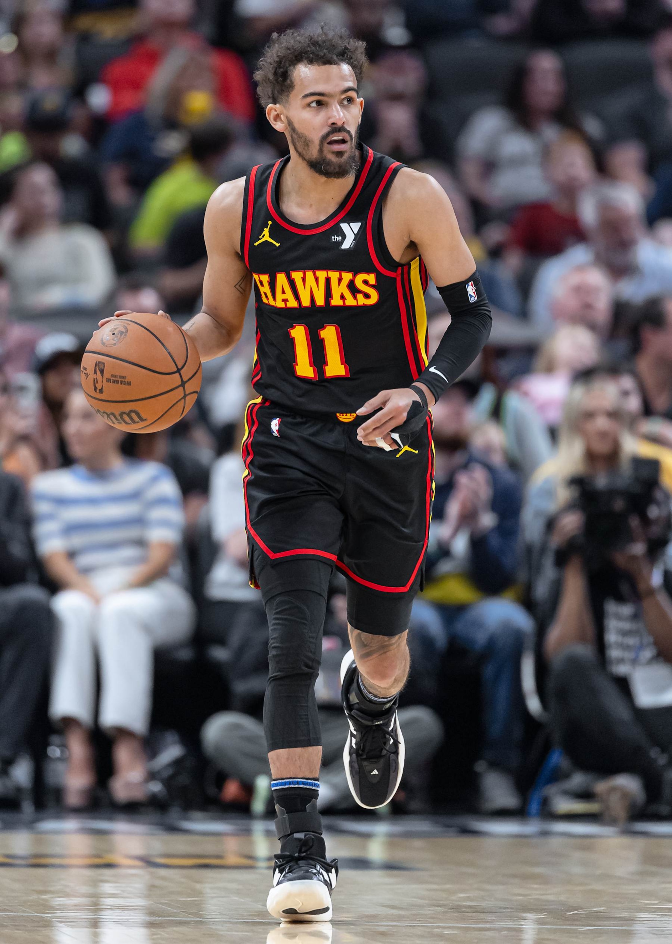 INDIANAPOLIS, INDIANA - APRIL 14: Trae Young #11 of the Atlanta Hawks brings the ball up court during the game against the Indiana Pacers at Gainbridge Fieldhouse on April 14, 2024 in Indianapolis, Indiana. NOTE TO USER: User expressly acknowledges and agrees that, by downloading and or using this photograph, User is consenting to the terms and conditions of the Getty Images License Agreement. (Photo by Michael Hickey/Getty Images)