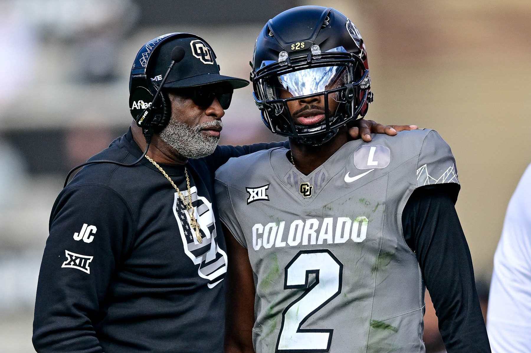 BOULDER, CO - NOVEMBER 16:  Head coach Deion Sanders of the Colorado Buffaloes celebrates with Shedeur Sanders #2 after a fourth quarter touchdown against the Utah Utes at Folsom Field on November 16, 2024 in Boulder, Colorado. (Photo by Dustin Bradford/Getty Images)