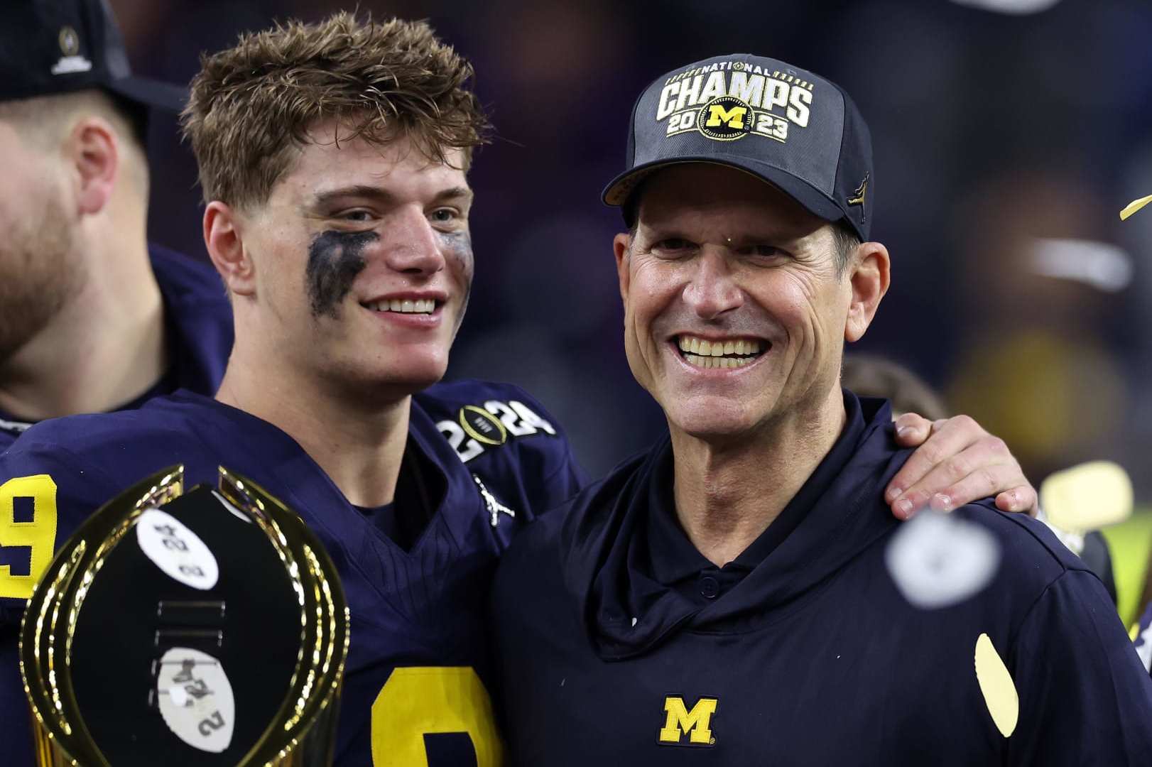 HOUSTON, TEXAS - JANUARY 08: J.J. McCarthy #9 and head coach Jim Harbaugh of the Michigan Wolverines celebrate after defeating the Washington Huskies during the 2024 CFP National Championship game at NRG Stadium on January 08, 2024 in Houston, Texas. Michigan defeated Washington 34-13. (Photo by Maddie Meyer/Getty Images)