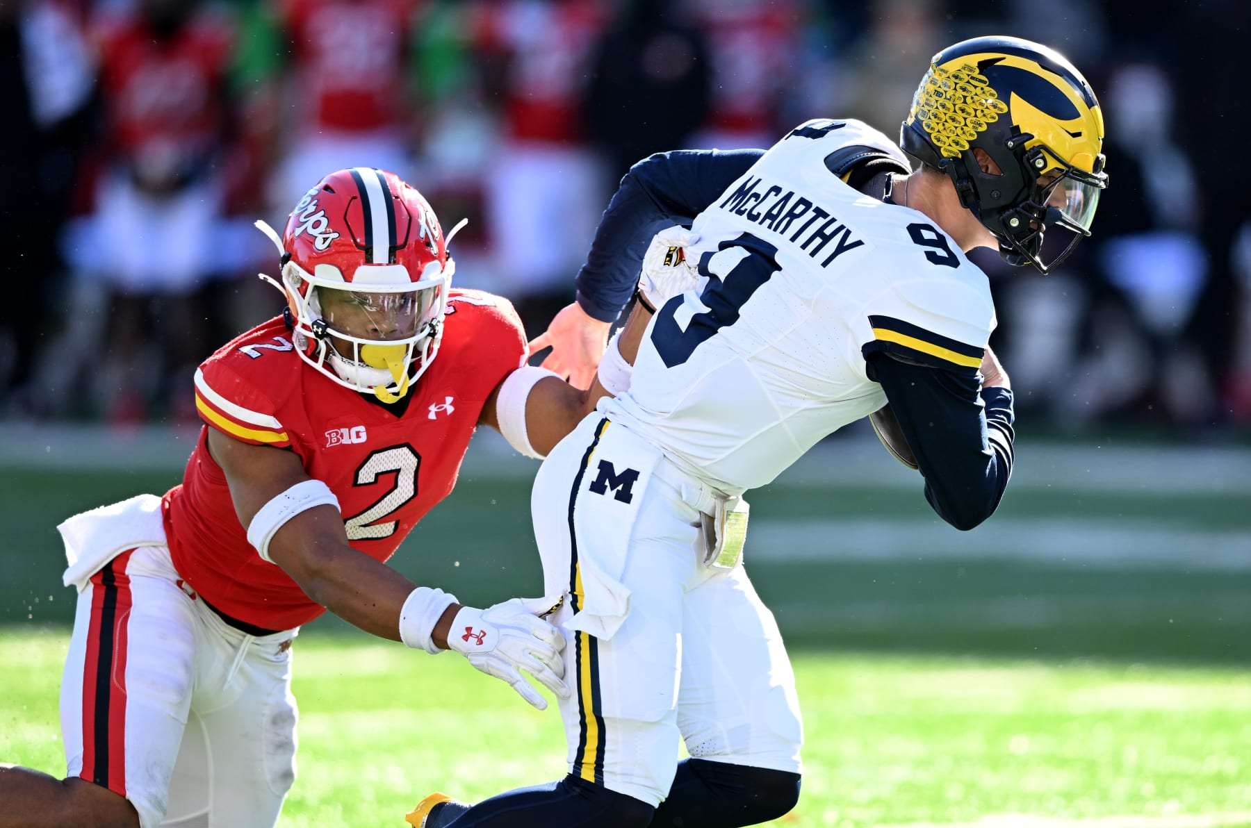 COLLEGE PARK, MARYLAND - NOVEMBER 18: J.J. McCarthy #9 of the Michigan Wolverines is tackled by Beau Brade #2 of the Maryland Terrapins in the second quarter at SECU Stadium on November 18, 2023 in College Park, Maryland. (Photo by G Fiume/Getty Images)
