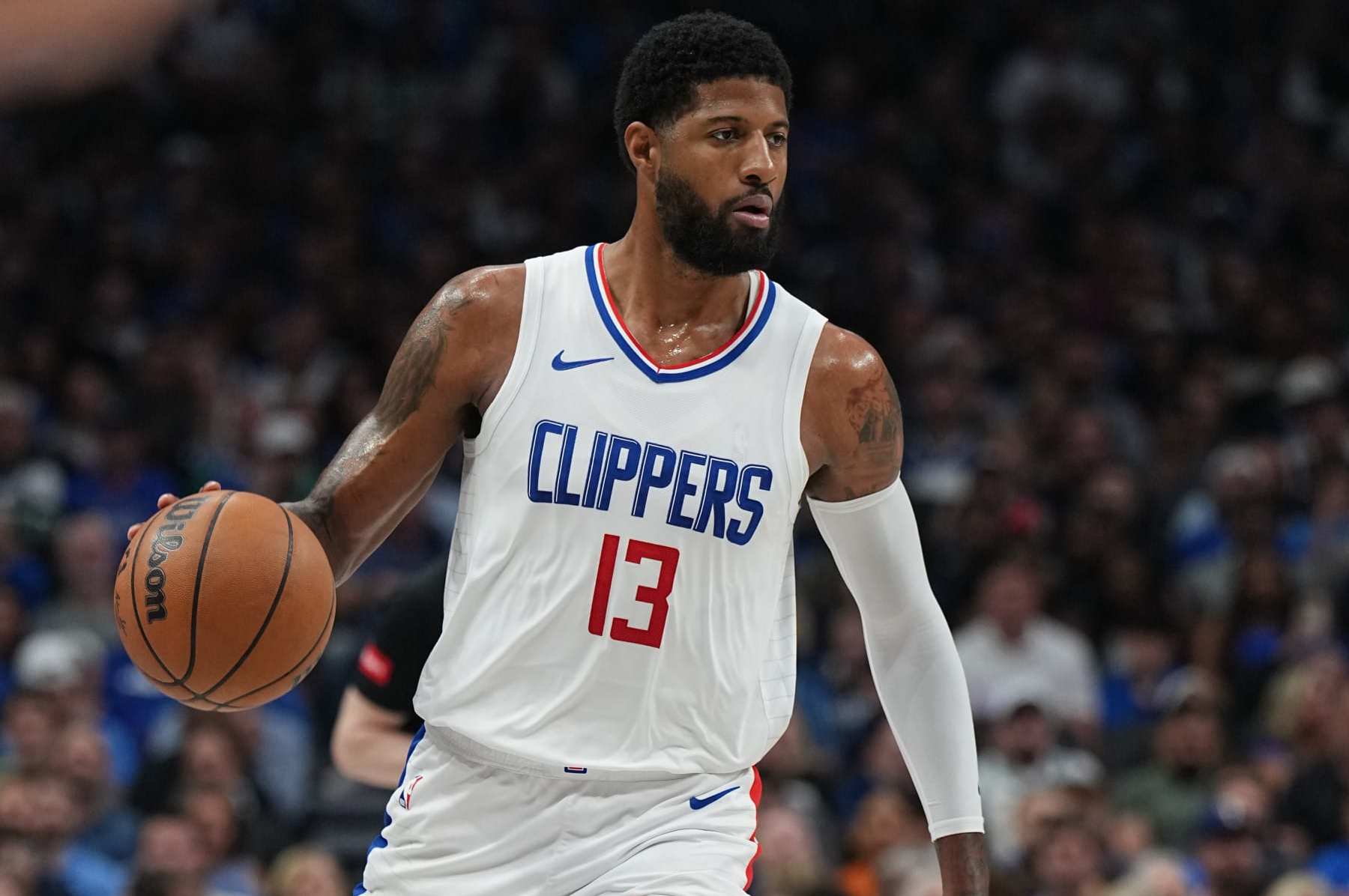 DALLAS, TX - APRIL 28: Paul George #13 of the LA Clippers handles the ball during the game against the Dallas Mavericks during Round 1 Game 4 of the 2024NBA Playoffs on April 28, 2024 at the American Airlines Center in Dallas, Texas. NOTE TO USER: User expressly acknowledges and agrees that, by downloading and or using this photograph, User is consenting to the terms and conditions of the Getty Images License Agreement. Mandatory Copyright Notice: Copyright 2024 NBAE (Photo by Glenn James/NBAE via Getty Images)