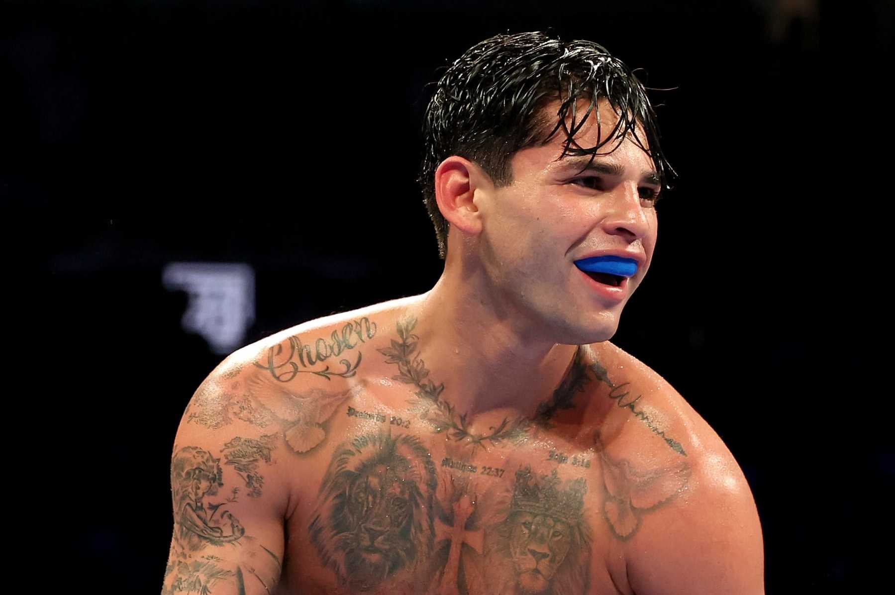NEW YORK, NEW YORK - APRIL 20: Ryan Garcia (white trunks) reacts against Devin Haney (gray trunks) during their WBC Super Lightweight title bout at Barclays Center on April 20, 2024 in New York City.  (Photo by Al Bello/Getty Images)