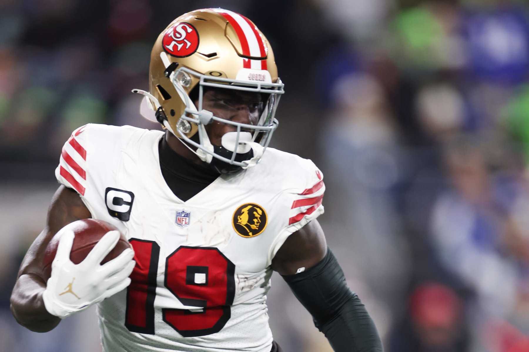 SEATTLE, WASHINGTON - NOVEMBER 23: Deebo Samuel #19 of the San Francisco 49ers runs with the ball during the second quarter against the Seattle Seahawks at Lumen Field on November 23, 2023 in Seattle, Washington. (Photo by Steph Chambers/Getty Images)