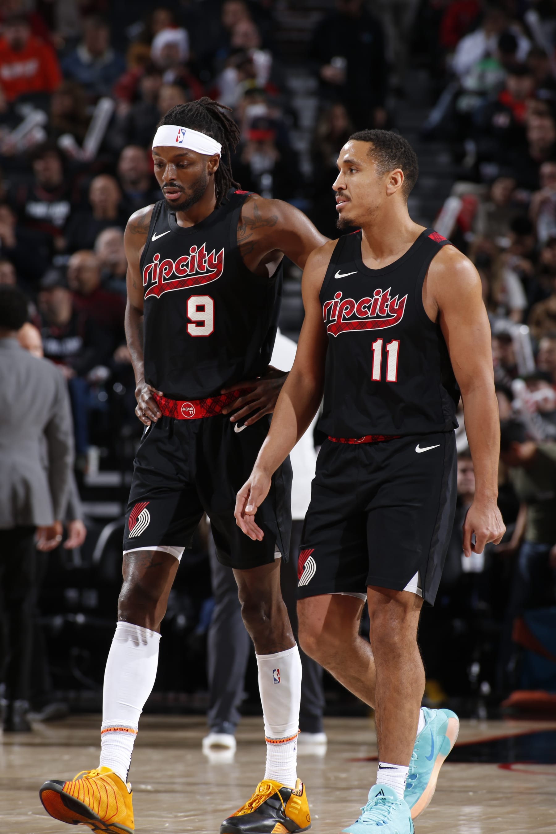 PORTLAND, OR - DECEMBER 21: Malcolm Brogdon #11 of the Portland Trail Blazers talks with Jerami Grant #9 during the game against the Washington Wizards on December 21, 2023 at the Moda Center Arena in Portland, Oregon. NOTE TO USER: User expressly acknowledges and agrees that, by downloading and or using this photograph, user is consenting to the terms and conditions of the Getty Images License Agreement. Mandatory Copyright Notice: Copyright 2023 NBAE (Photo by Cameron Browne/NBAE via Getty Images)