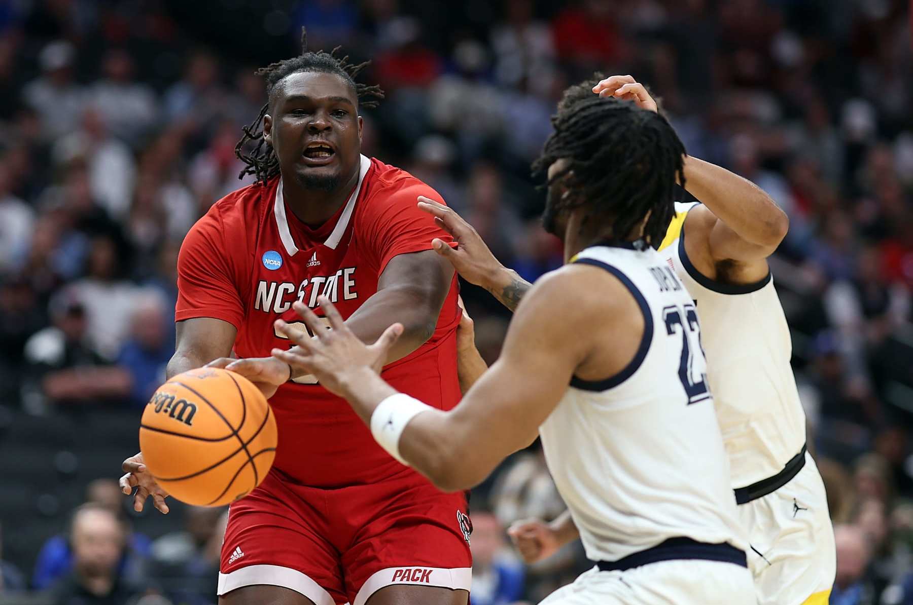 DALLAS, TEXAS - MARCH 29: DJ Burns Jr. #30 of the North Carolina State Wolfpack controls the ball as David Joplin #23 of the Marquette Golden Eagles defends during the first half in the Sweet 16 round of the NCAA Men's Basketball Tournament at American Airlines Center on March 29, 2024 in Dallas, Texas. (Photo by Patrick Smith/Getty Images)