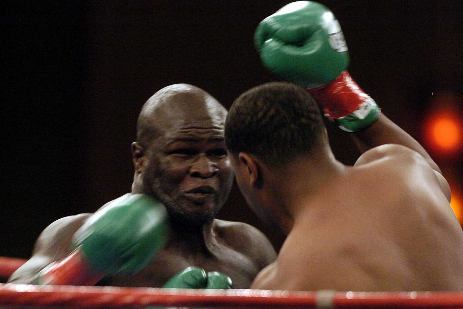 James Toney, left, fires a punch on Rydell Booker, right, during the first round of their WBC and IBA Heavyweight Championship Bout held at Pechanga Resort and Casino in Temecula, Calif. Thursday, Sept. 23, 2004. (AP Photo/Denis Poroy)