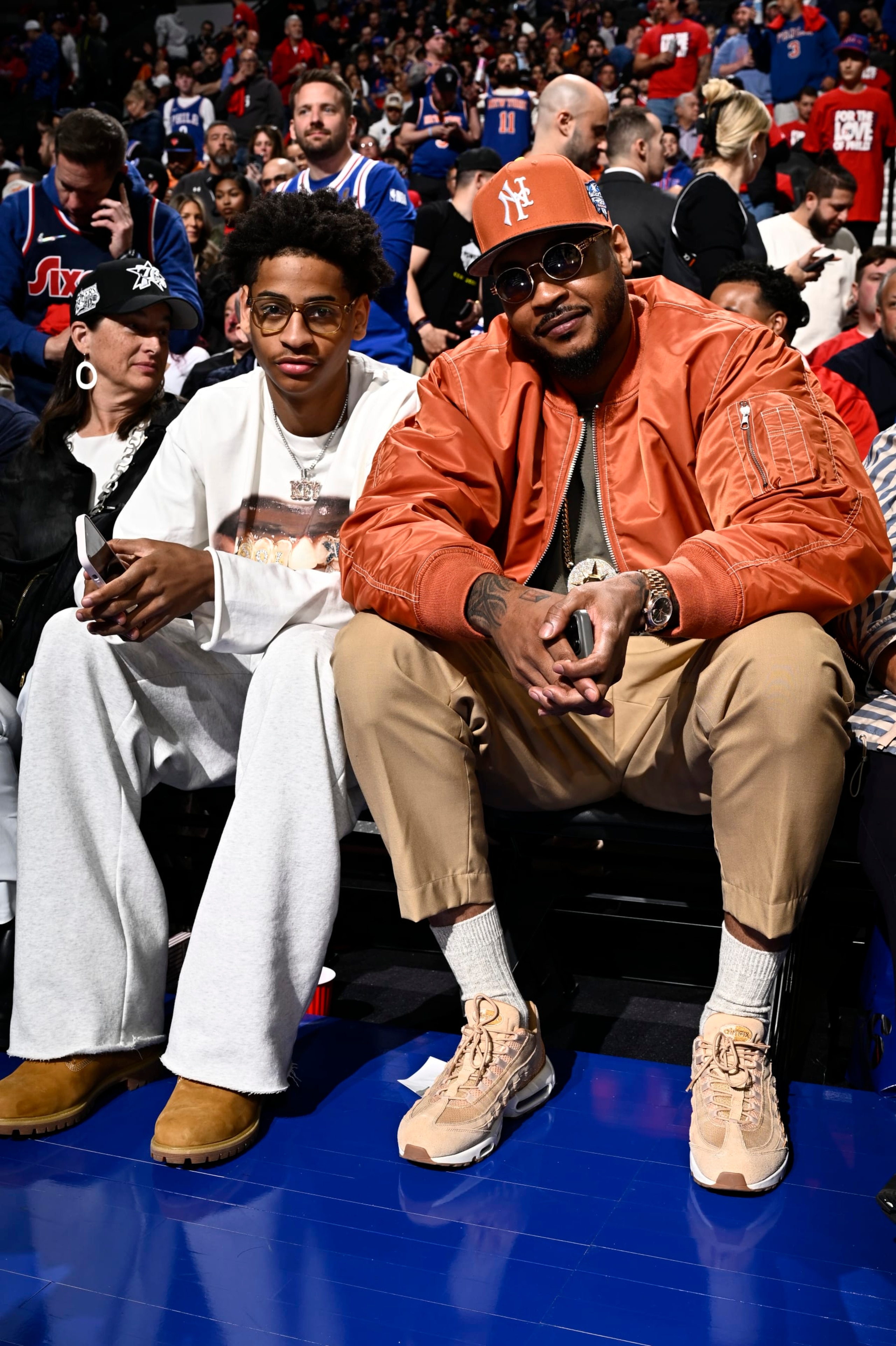 PHILADELPHIA, PA - APRIL 25: Carmelo Anthony and Kiyan Anthony attend the game between the New York Knicks and the Philadelphia 76ers during Round 1 Game 3 of the 2024 NBA Playoffs on April 25, 2024 at the Wells Fargo Center in Philadelphia, Pennsylvania NOTE TO USER: User expressly acknowledges and agrees that, by downloading and/or using this Photograph, user is consenting to the terms and conditions of the Getty Images License Agreement. Mandatory Copyright Notice: Copyright 2024 NBAE (Photo by David Dow/NBAE via Getty Images)