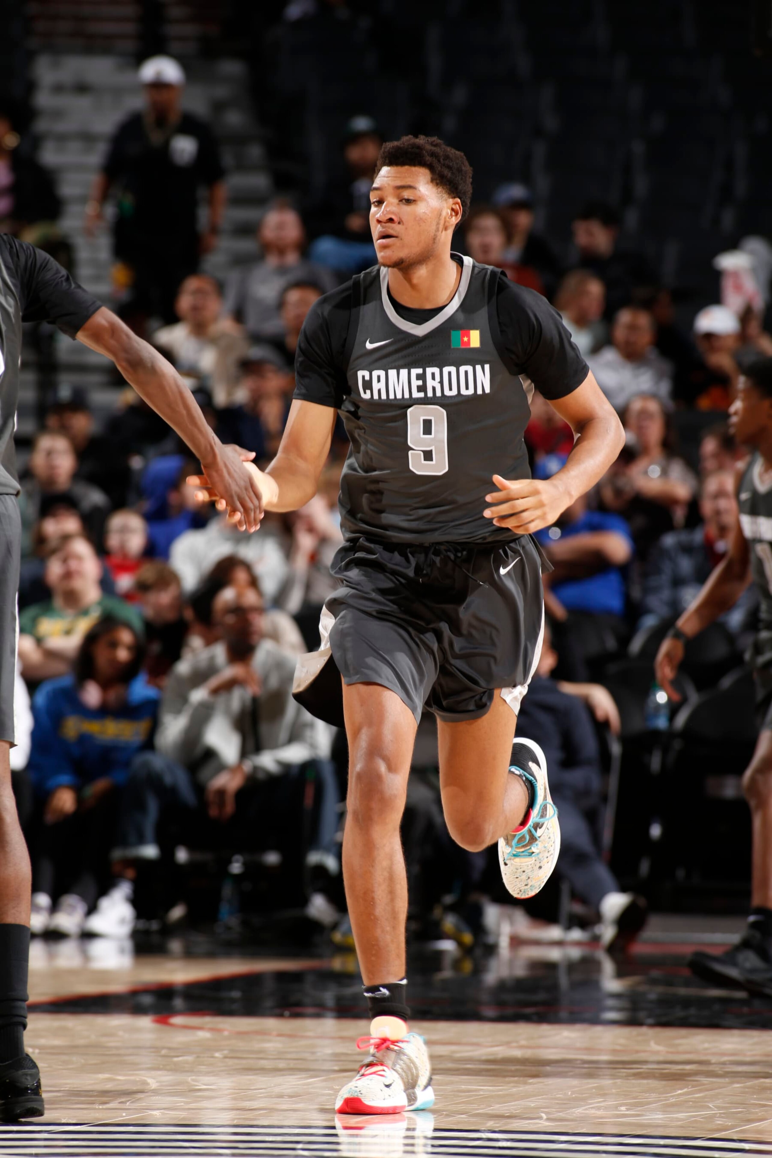 PORTLAND, OR - APRIL 13: Ulrich Chomche #9 of Team World looks on during the game against Team USA during the 2024 Nike Hoop Summit on April 13, 2024 at the Moda Center Arena in Portland, Oregon. NOTE TO USER: User expressly acknowledges and agrees that, by downloading and or using this photograph, user is consenting to the terms and conditions of the Getty Images License Agreement. Mandatory Copyright Notice: Copyright 2024 NBAE (Photo by Cameron Browne/NBAE via Getty Images)
