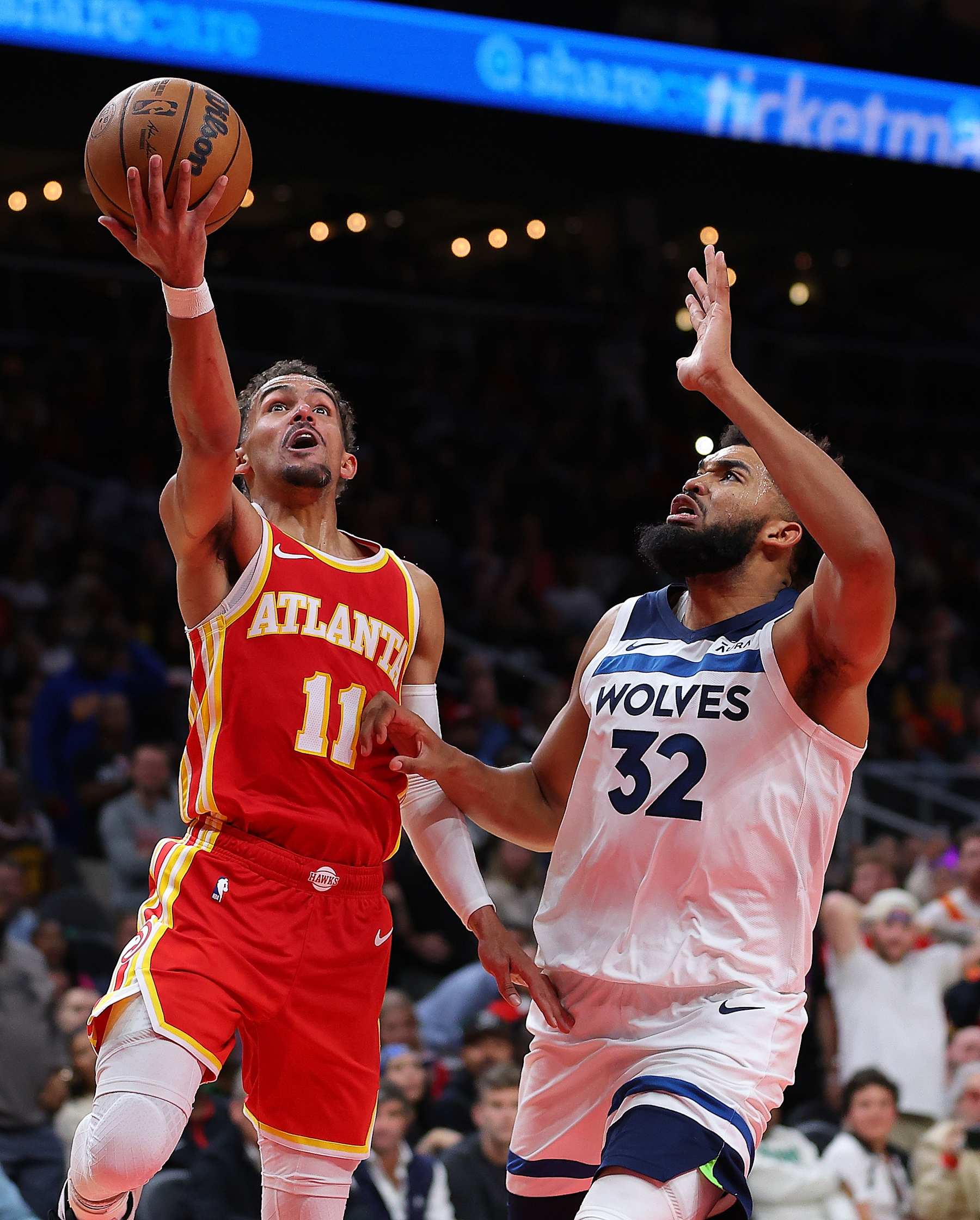 ATLANTA, GEORGIA - OCTOBER 30:  Trae Young #11 of the Atlanta Hawks drives against Karl-Anthony Towns #32 of the Minnesota Timberwolves during the fourth quarter at State Farm Arena on October 30, 2023 in Atlanta, Georgia.  NOTE TO USER: User expressly acknowledges and agrees that, by downloading and/or using this photograph, user is consenting to the terms and conditions of the Getty Images License Agreement.  (Photo by Kevin C. Cox/Getty Images)