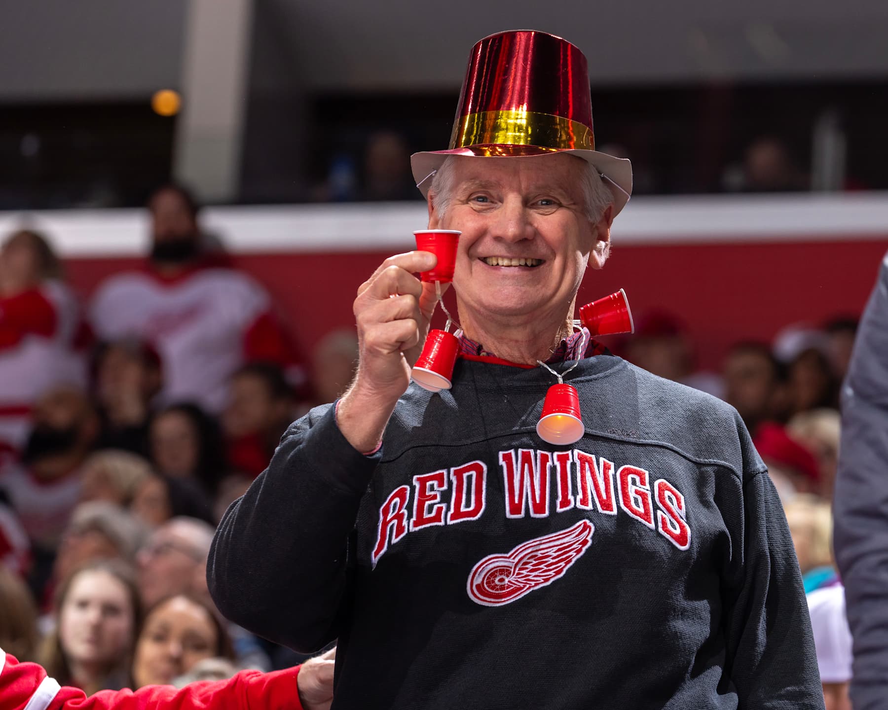 DETROIT, MI - DECEMBER 31: A Detroit Red Wings fan celebrates the New Year's Eve game between the Detroit Red Wings and the Boston Bruins at Little Caesars Arena on December 31, 2023 in Detroit, Michigan. (Photo by Dave Reginek/NHLI via Getty Images)