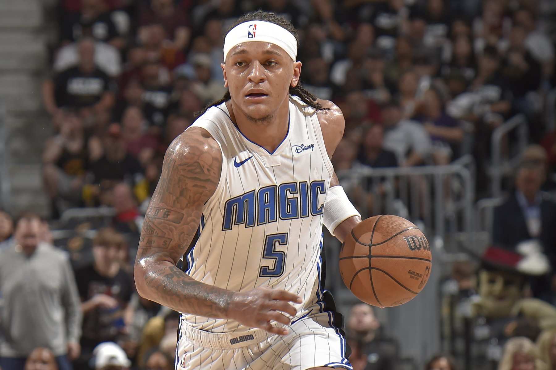 CLEVELAND, OH - MAY 5: Paolo Banchero #5 of the Orlando Magic brings the ball up court during the game against the Cleveland Cavaliers during Round 1 Game 7 of the 2024 NBA Playoffs on May 5, 2024 at Rocket Mortgage FieldHouse in Cleveland, Ohio. NOTE TO USER: User expressly acknowledges and agrees that, by downloading and/or using this Photograph, user is consenting to the terms and conditions of the Getty Images License Agreement. Mandatory Copyright Notice: Copyright 2024 NBAE (Photo by David Liam Kyle/NBAE via Getty Images)