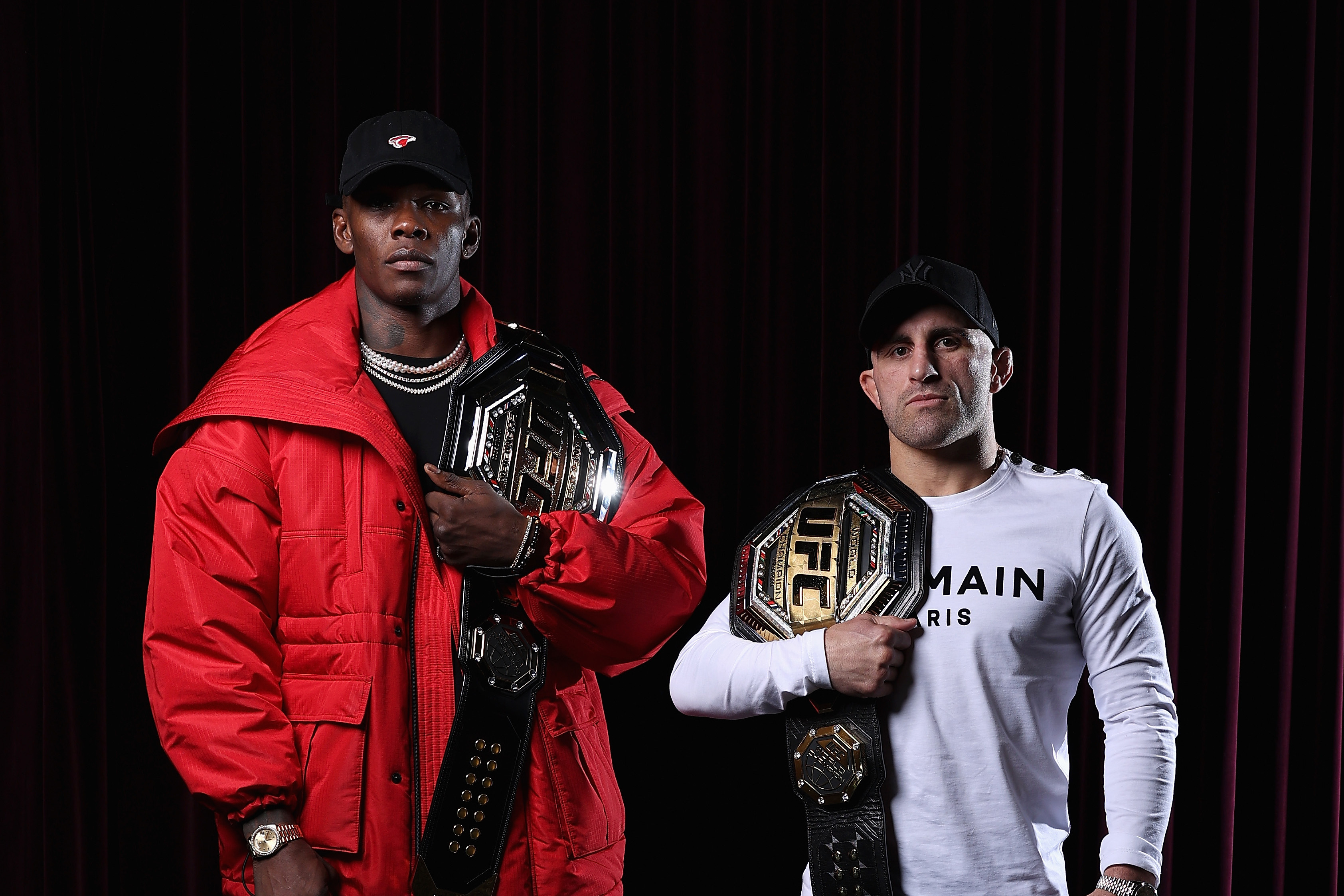SYDNEY, AUSTRALIA - JUNE 21: UFC middleweight champion Israel Adesanya and UFC featherweight champion Alexander Volkanovski pose ahead of a media opportunity in promotion of UFC 276 (Adesanya v Cannonier) and UFC 277 (Pena v Nunes), at The Star on June 21, 2022 in Sydney, Australia. (Photo by Cameron Spencer/Getty Images for UFC)