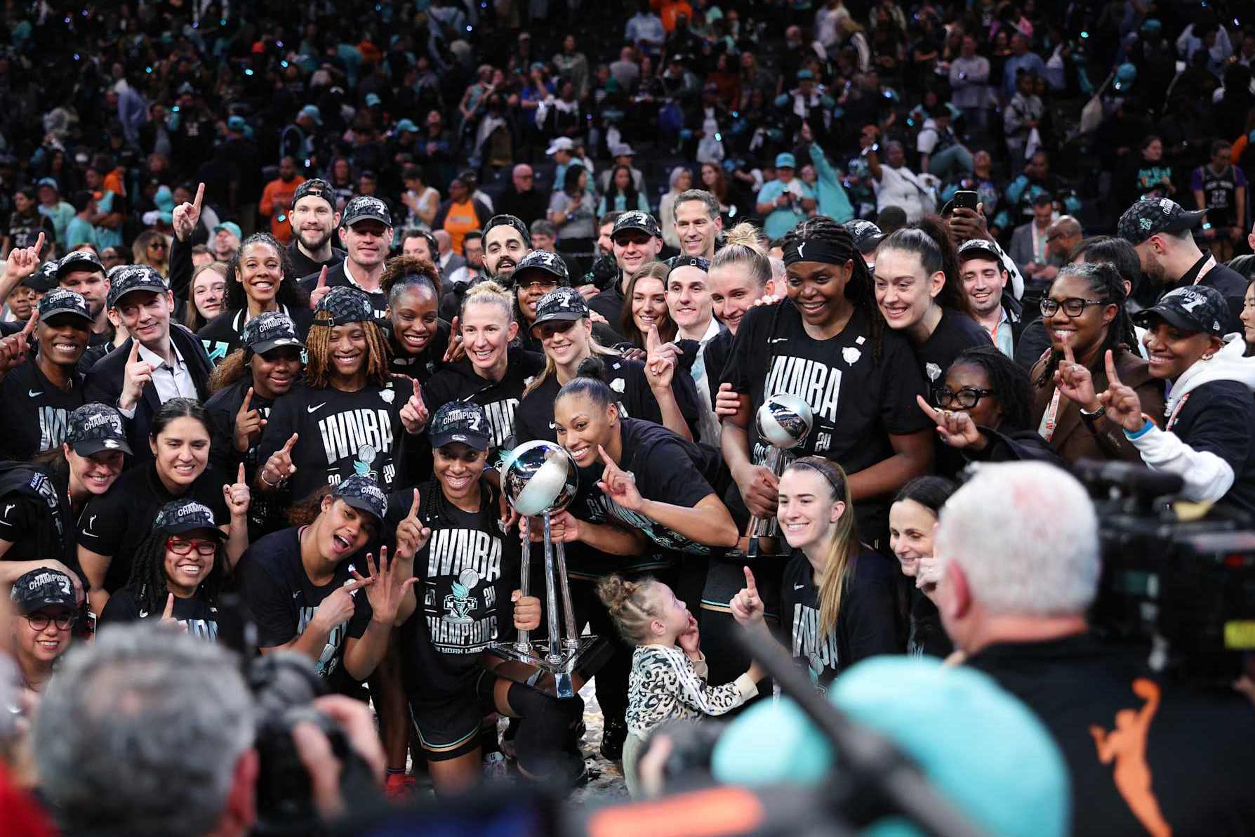 NEW YORK, NEW YORK - OCTOBER 20: New York Liberty players pose for a photo with the WNBA Championship Trophy after winning Game Five of the WNBA Finals at Barclays Center on October 20, 2024 in New York City. (Photo by Elsa/Getty Images)