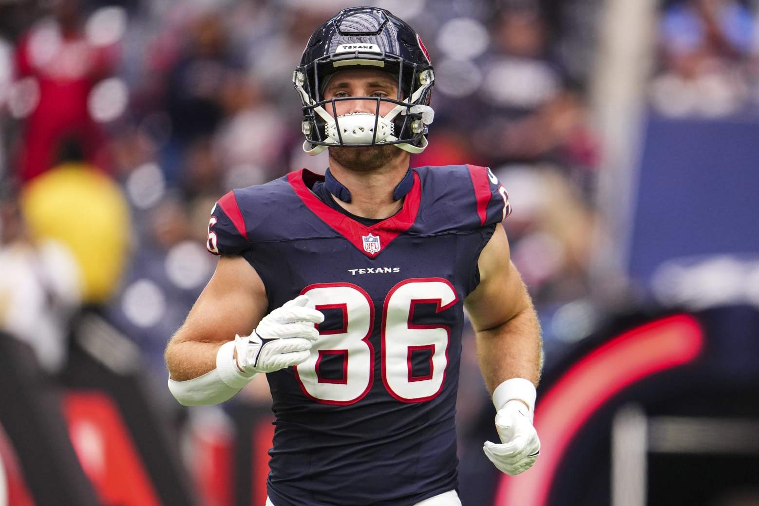 HOUSTON, TX - OCTOBER 15: Dalton Schultz #86 of the Houston Texans runs out of the tunnel prior to an NFL football game against the New Orleans Saints at NRG Stadium on October 15, 2023 in Houston, Texas. (Photo by Cooper Neill/Getty Images)