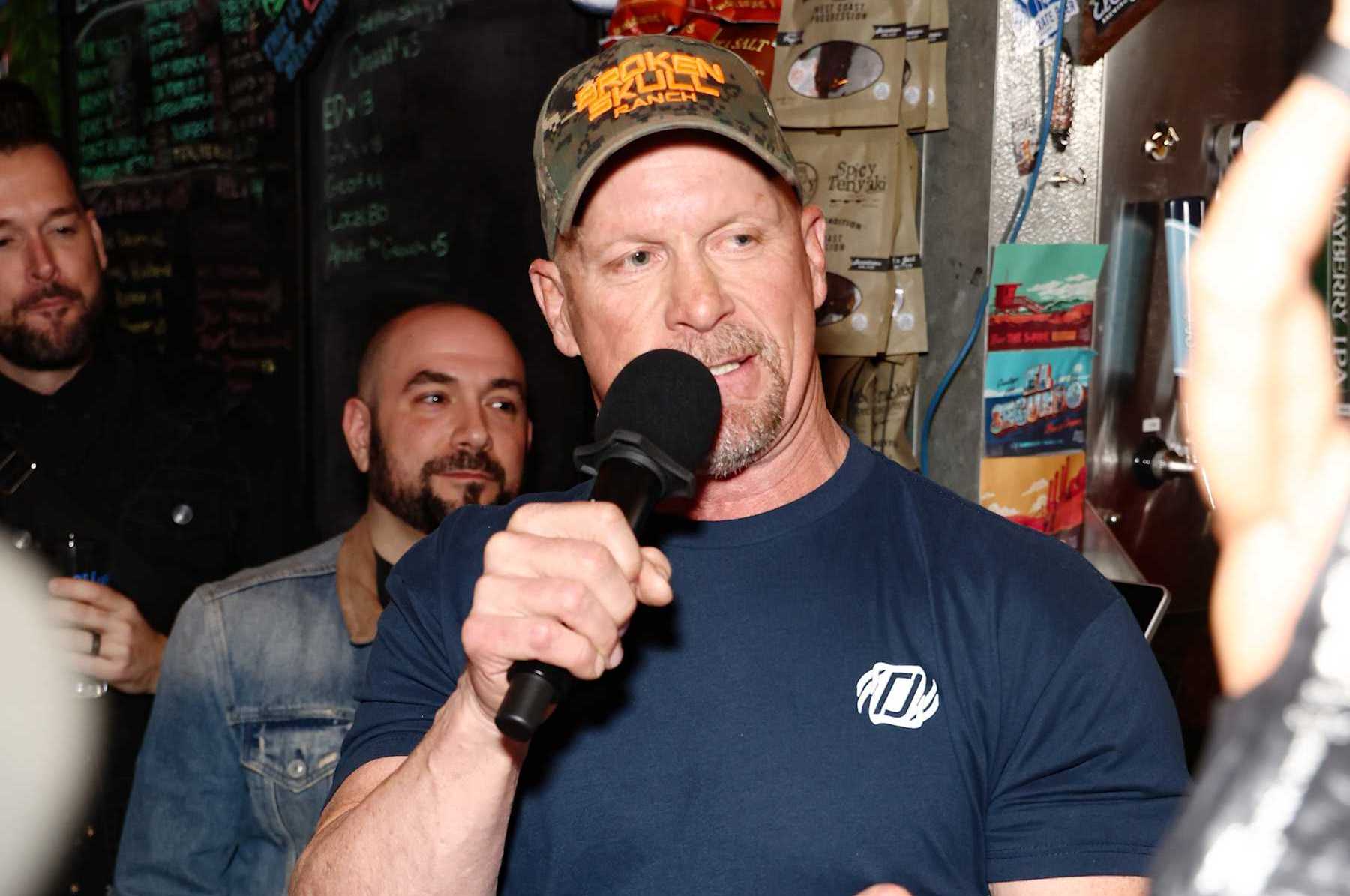 EL SEGUNDO, CALIFORNIA - MARCH 16: "Stone Cold" Steve Austin (C) speaks during WWE 2K23 Launch Event at El Segundo Brewing Company on March 16, 2023 in El Segundo, California. (Photo by Joe Scarnici/Getty Images for 2K )