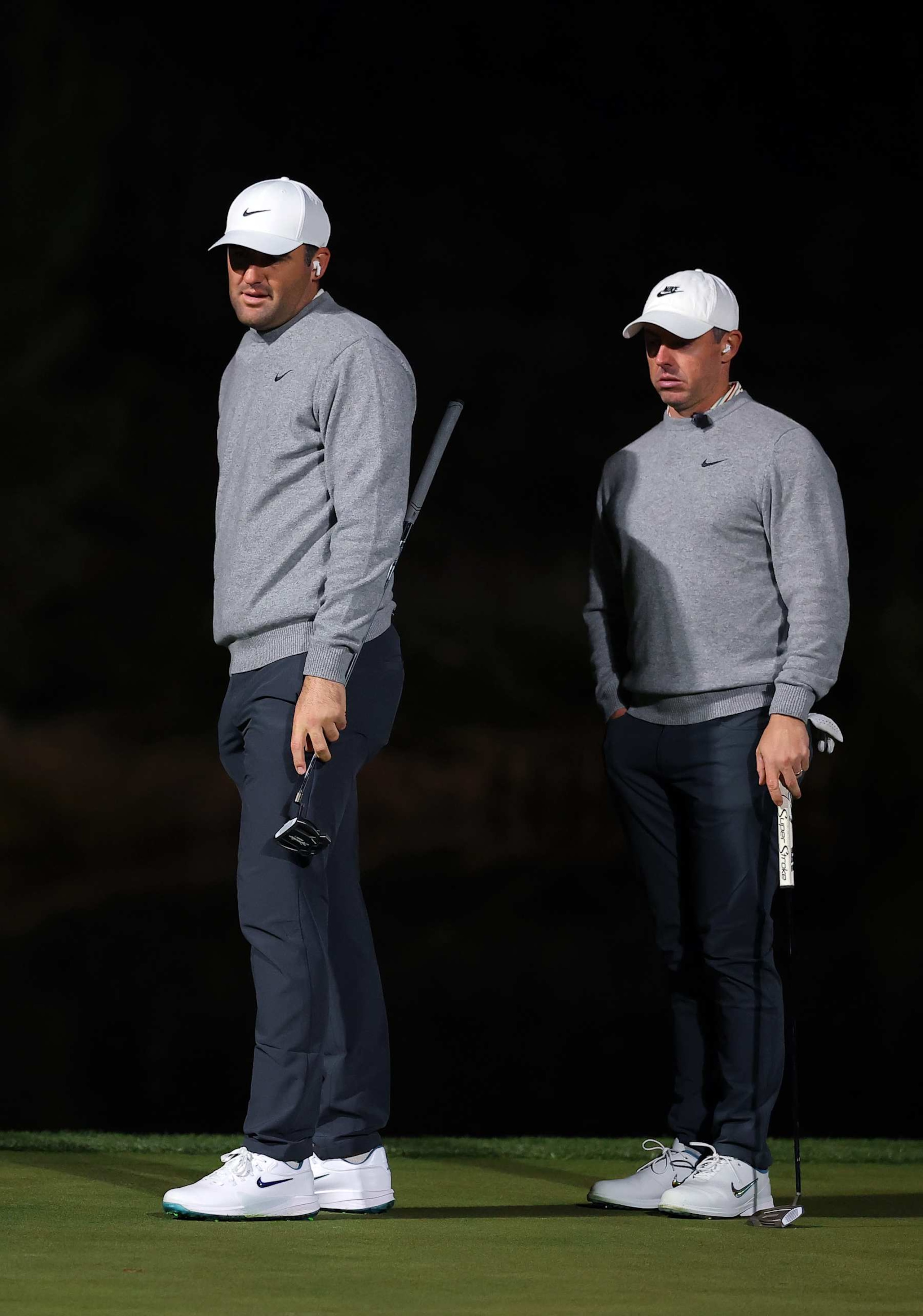 LAS VEGAS, NEVADA - DECEMBER 17: Scottie Scheffler (L) and Rory McIlroy of the PGA Tour look on during The Showdown: McIlroy and Scheffler v DeChambeau and Koepka at Shadow Creek Golf Course on December 17, 2024 in Las Vegas, Nevada.  (Photo by Kevin C. Cox/Getty Images for The Showdown)