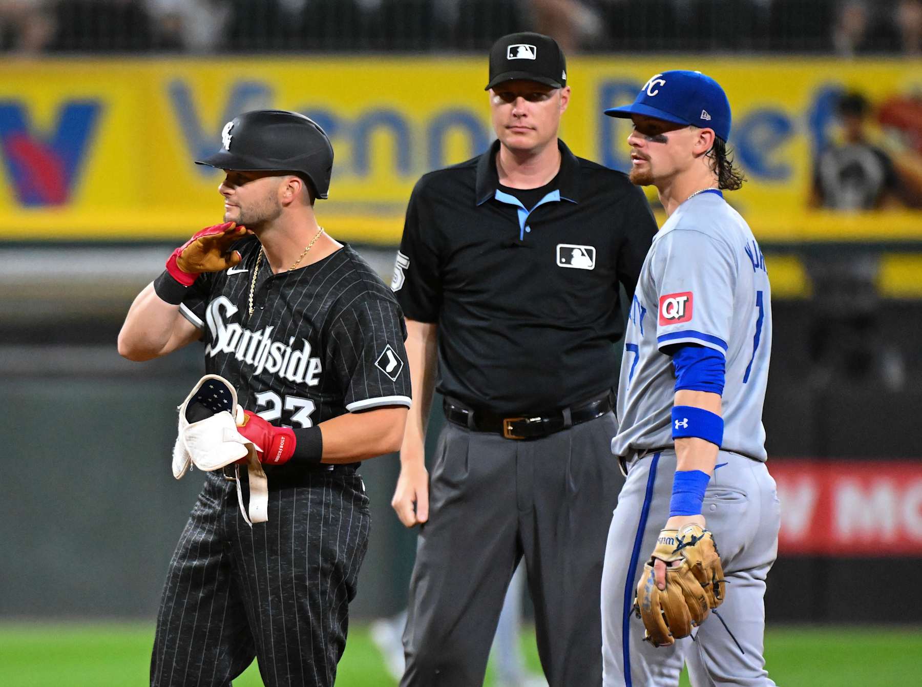 CHICAGO, ILLINOIS - JULY 29: Andrew Benintendi #23 of the Chicago White Sox reacts after an RBI double while Bobby Witt Jr. #7 of the Kansas City Royals looks on during the sixth inning of a game at Guaranteed Rate Field on July 29, 2024 in Chicago, Illinois. (Photo by Nuccio DiNuzzo/Getty Images)