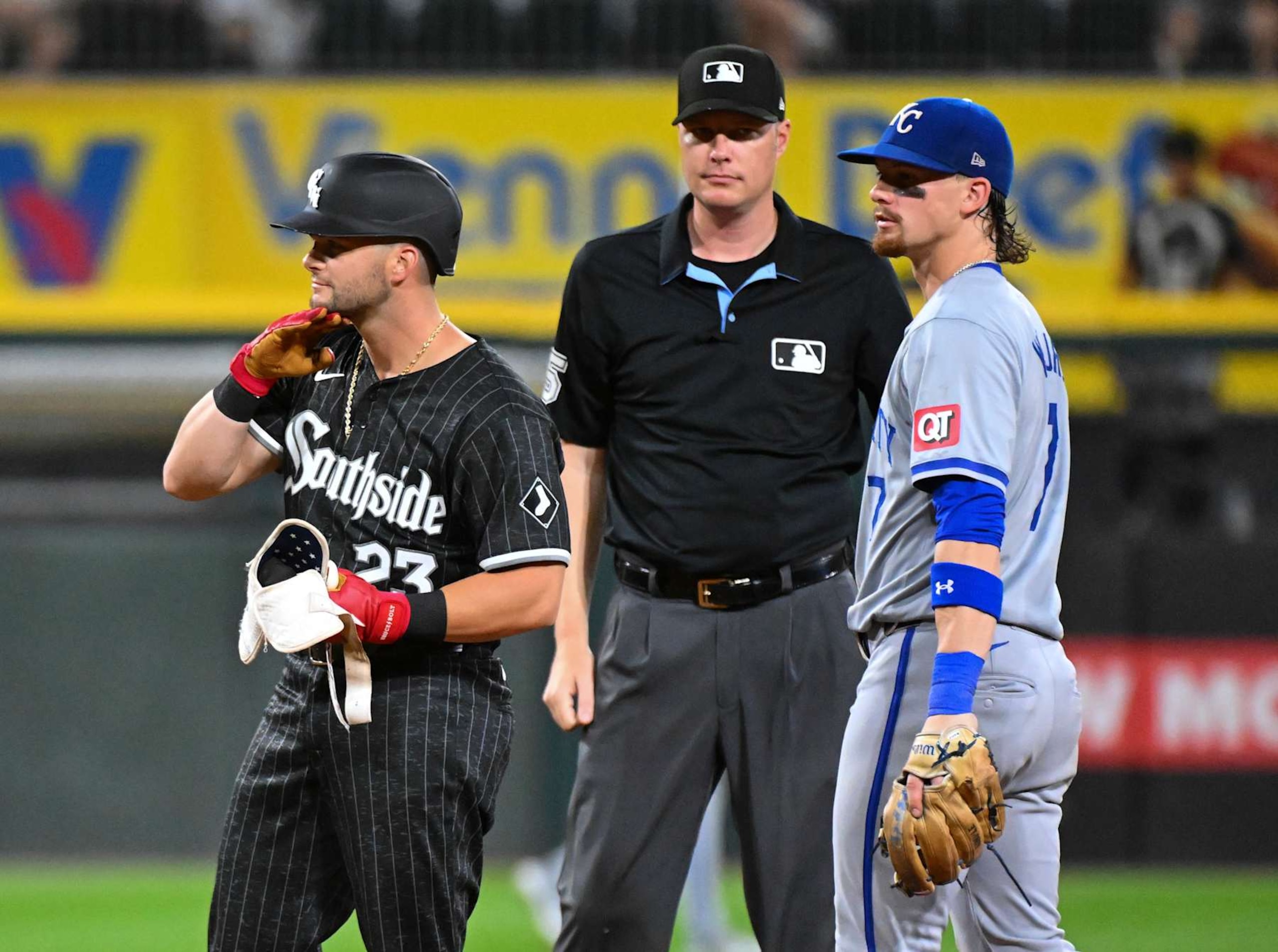CHICAGO, ILLINOIS - JULY 29: Andrew Benintendi #23 of the Chicago White Sox reacts after an RBI double while Bobby Witt Jr. #7 of the Kansas City Royals looks on during the sixth inning of a game at Guaranteed Rate Field on July 29, 2024 in Chicago, Illinois. (Photo by Nuccio DiNuzzo/Getty Images)