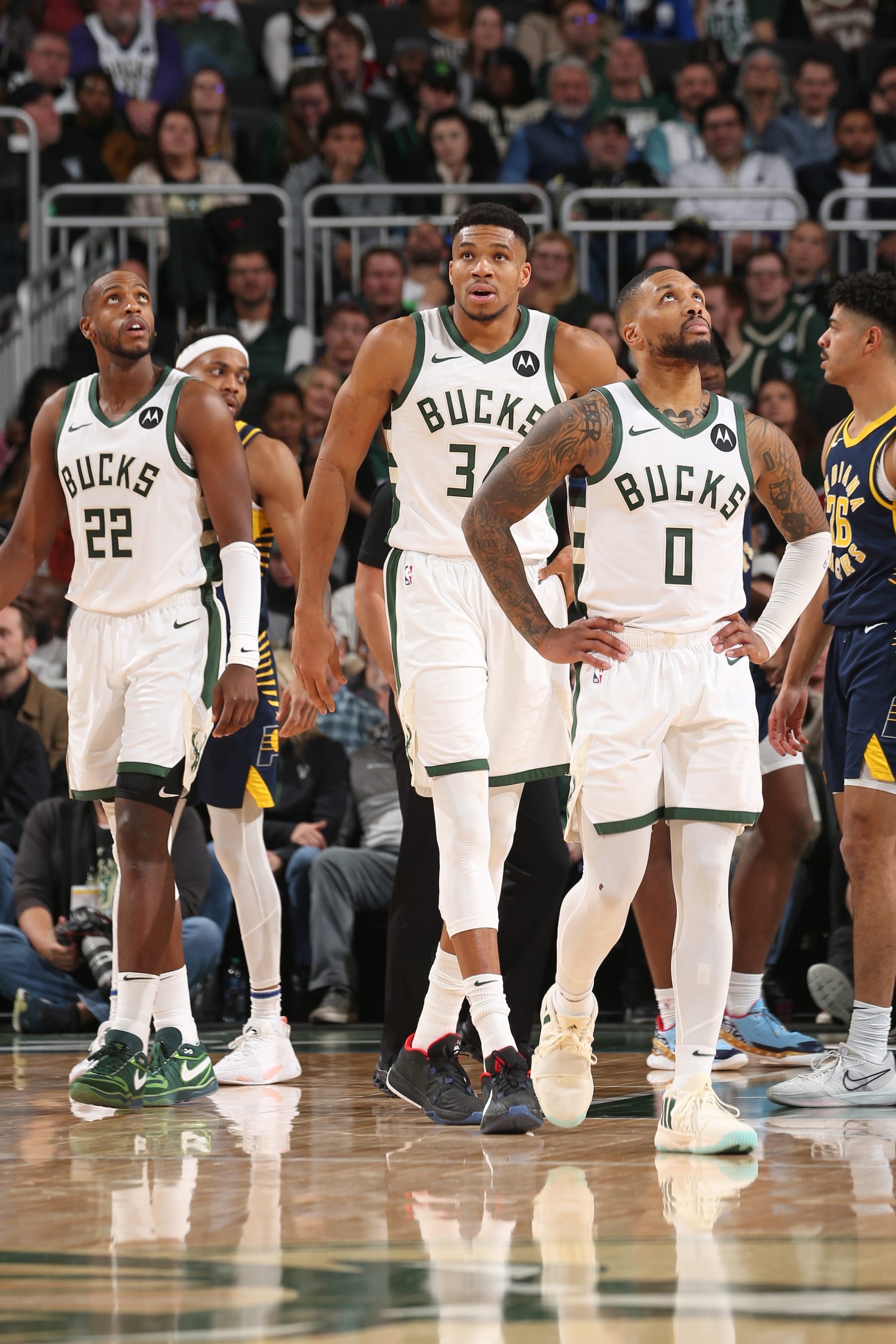MILWAUKEE, WI - DECEMBER 13: Khris Middleton #22, Giannis Antetokounmpo #34 and Damian Lillard #0 of the Milwaukee Bucks look on during the game against the Indiana Pacers on December 13, 2023 at the Fiserv Forum Center in Milwaukee, Wisconsin. NOTE TO USER: User expressly acknowledges and agrees that, by downloading and or using this Photograph, user is consenting to the terms and conditions of the Getty Images License Agreement. Mandatory Copyright Notice: Copyright 2023 NBAE (Photo by Gary Dineen/NBAE via Getty Images).