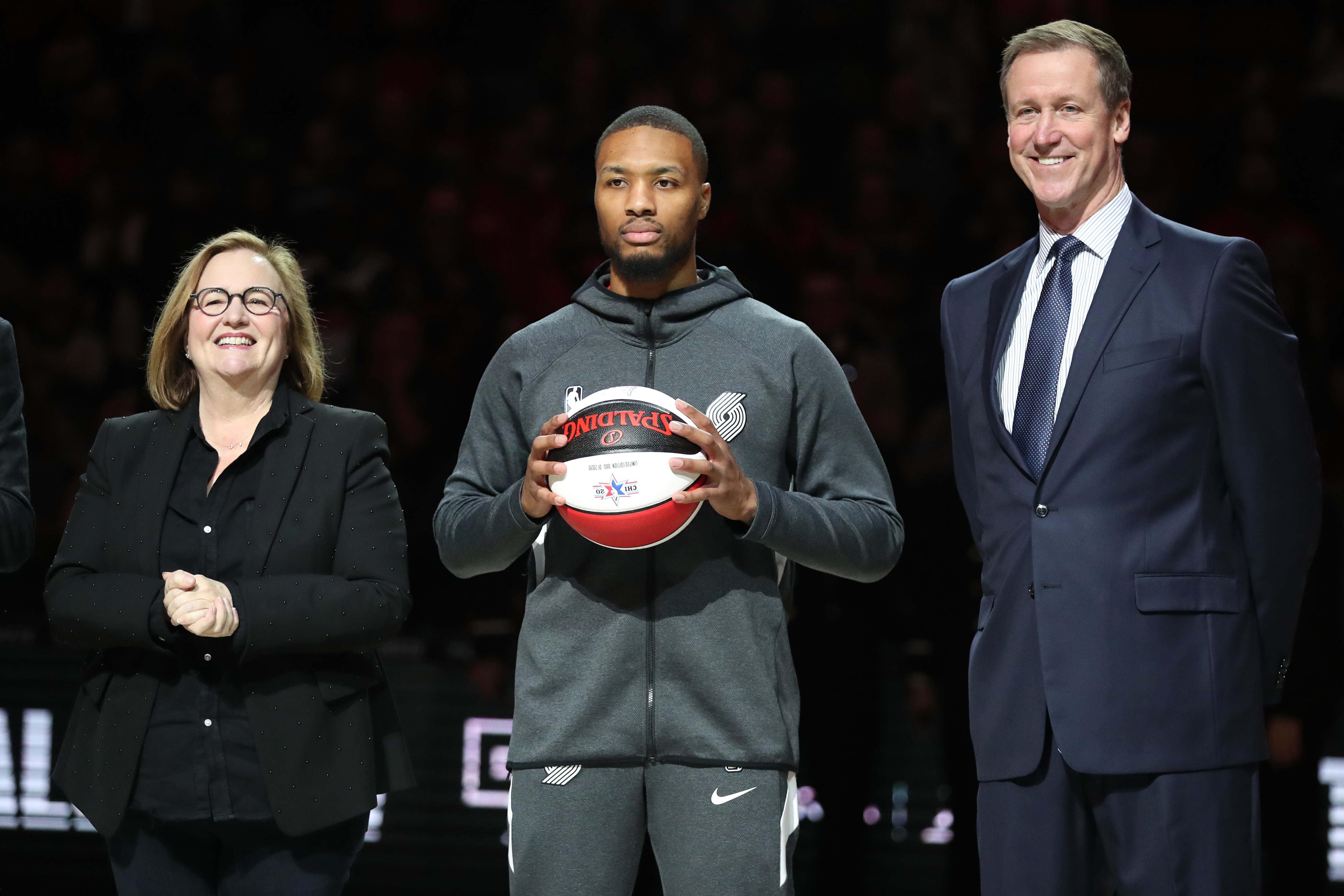 PORTLAND, OREGON - FEBRUARY 09: Damian Lillard #0 of the Portland Trail Blazers is honored for his NBA All Star selection by Portland Trail Blazers Owner Jody Allen and Head Coach Terry Stotts of the Portland Trail Blazers prior to taking on the Miami Heat at Moda Center on February 09, 2020 in Portland, Oregon. NOTE TO USER: User expressly acknowledges and agrees that, by downloading and or using this photograph, User is consenting to the terms and conditions of the Getty Images License Agreement. (Photo by Abbie Parr/Getty Images)