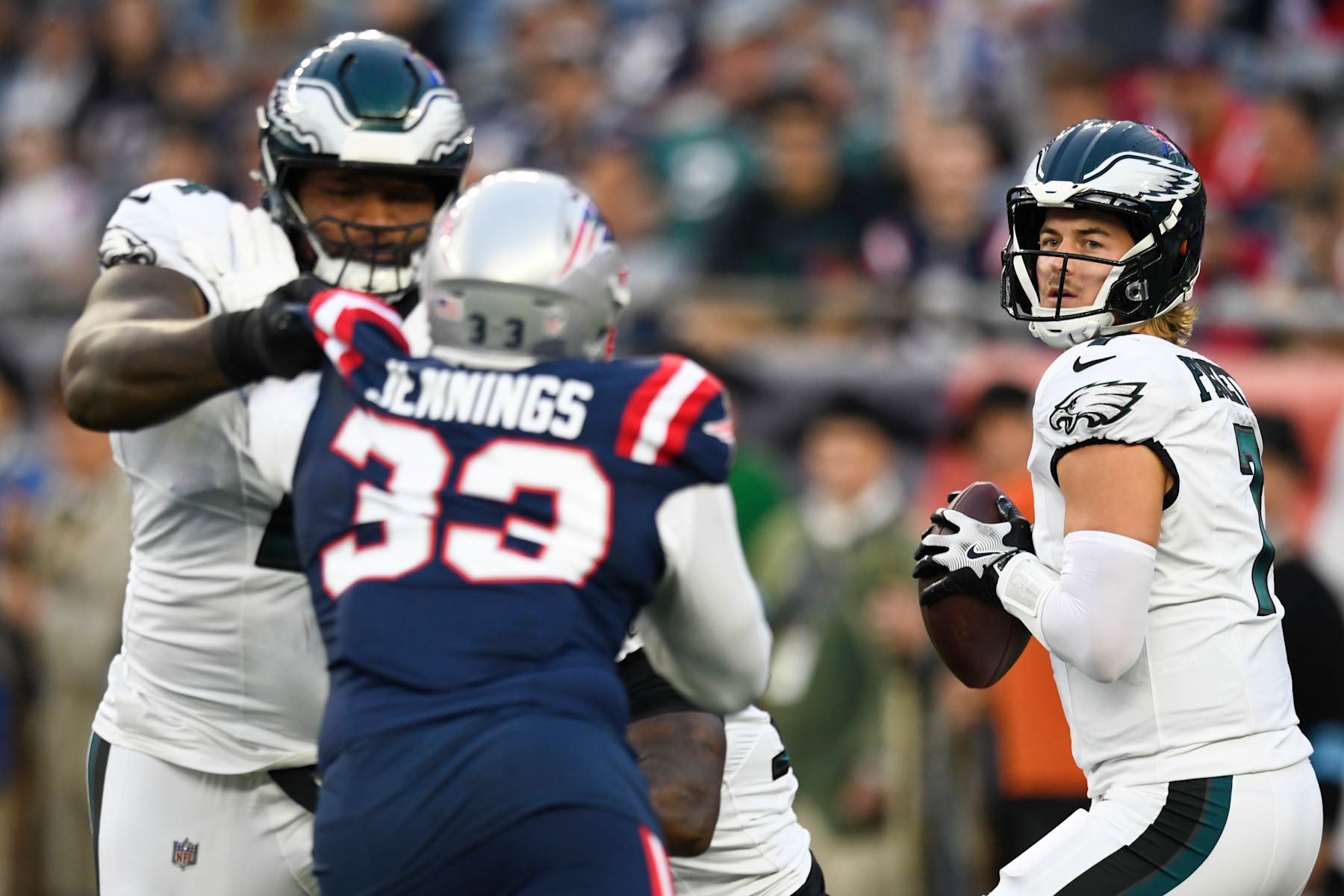 Philadelphia Eagles quarterback Kenny Pickett drops back to pass while being protected by the offensive line. 